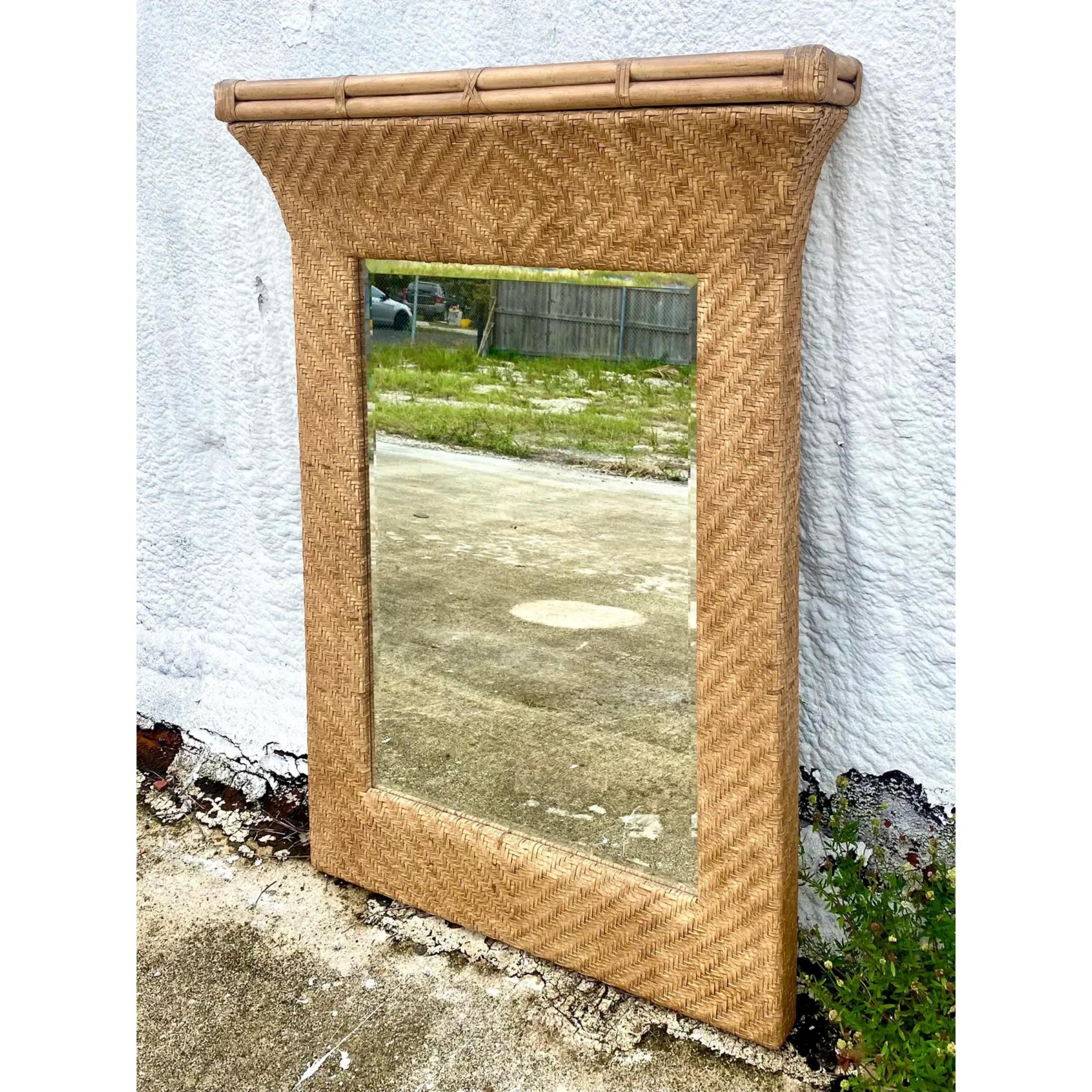 Incredible Henredon Coastal mirror. Made from a beautiful woven leather and trimmed in thick bamboo. A flared top and grand size. An impressive addition to any room
