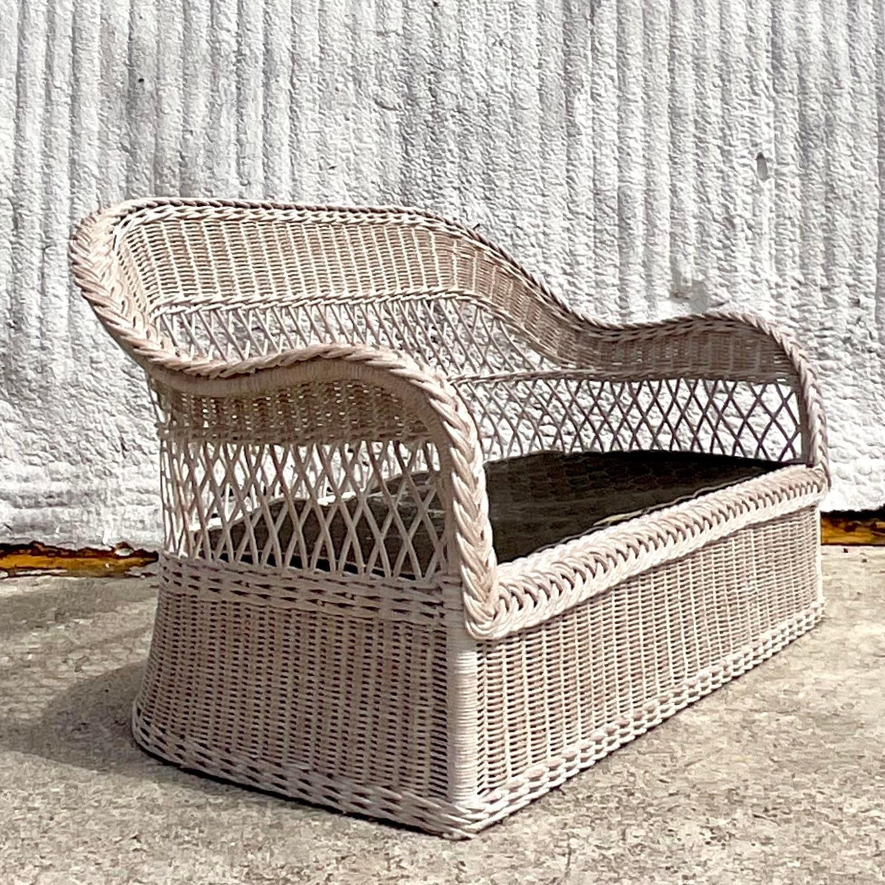 A fantastic vintage Coastal loveseat. Made by the iconic Henry Link and tagged on the seat. A chic braided rattan trim and a gorgeous washed finish. Thr coordinating chairs are also available on my page. Acquired from a Palm Beach estate. 