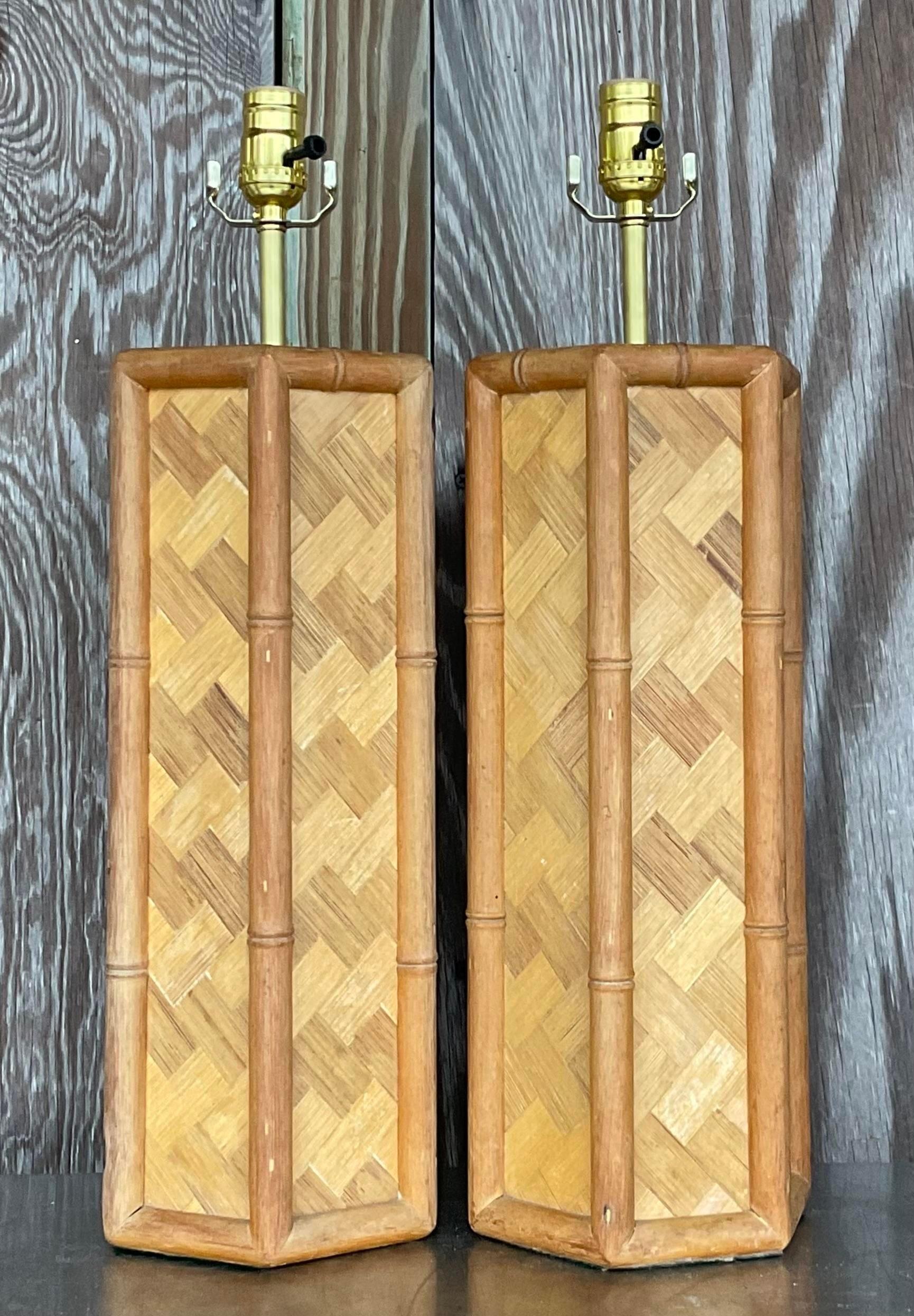 A fabulous pair of vintage Coastal table lamps. A chic parquet rattan in a cool hexagon shape. Trimmed in full rattan. Fully restored with all new wiring and hardware. Acquired from a Palm Beach estate.