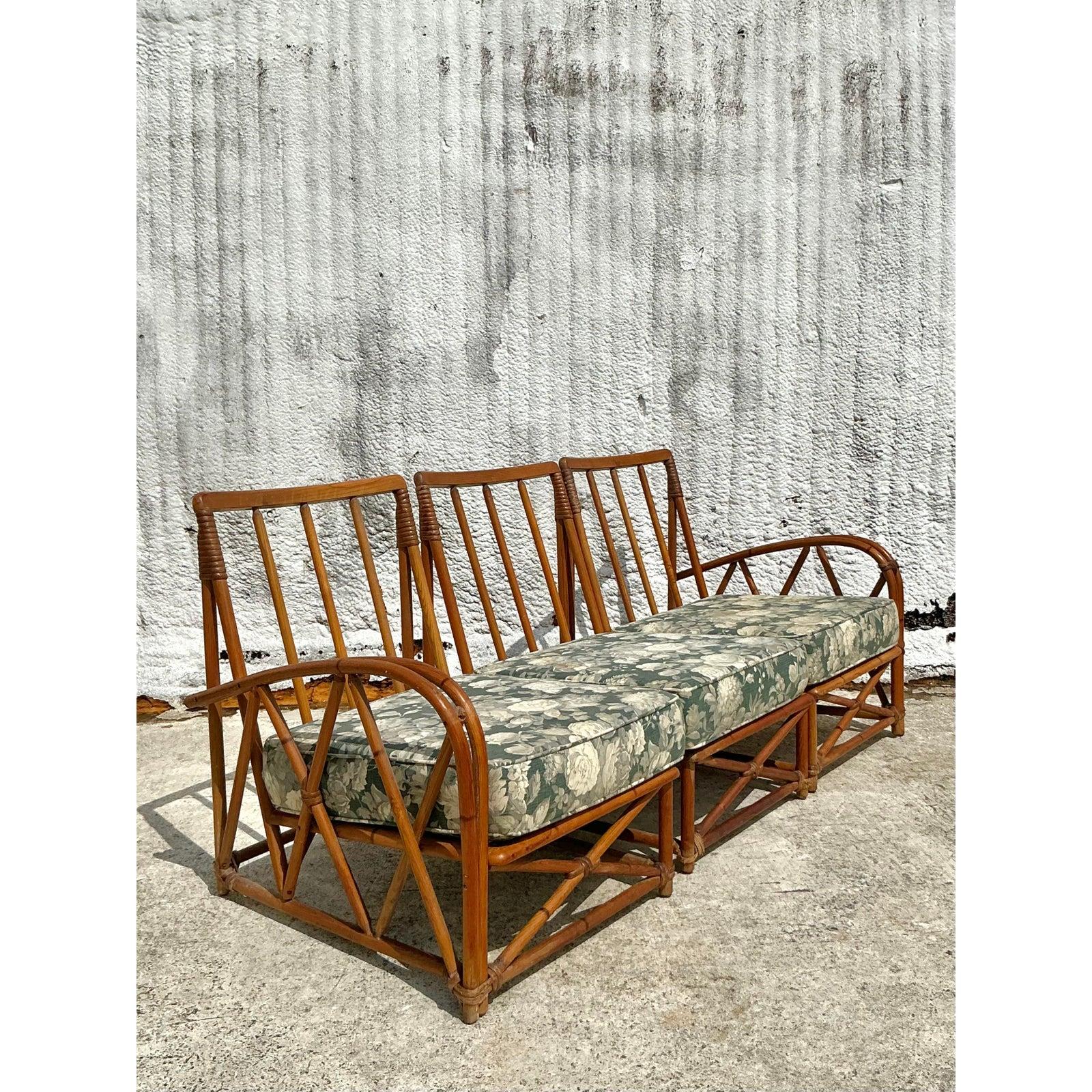Dieses gebogene Rattansofa im Vintage-Stil, das Heywood-Wakefield zugeschrieben wird, verleiht Ihrem Raum zeitlosen tropischen Charme. Dieses Möbelstück aus der Mitte des Jahrhunderts mit seinen wunderschön geschwungenen Armen und dem geometrischen