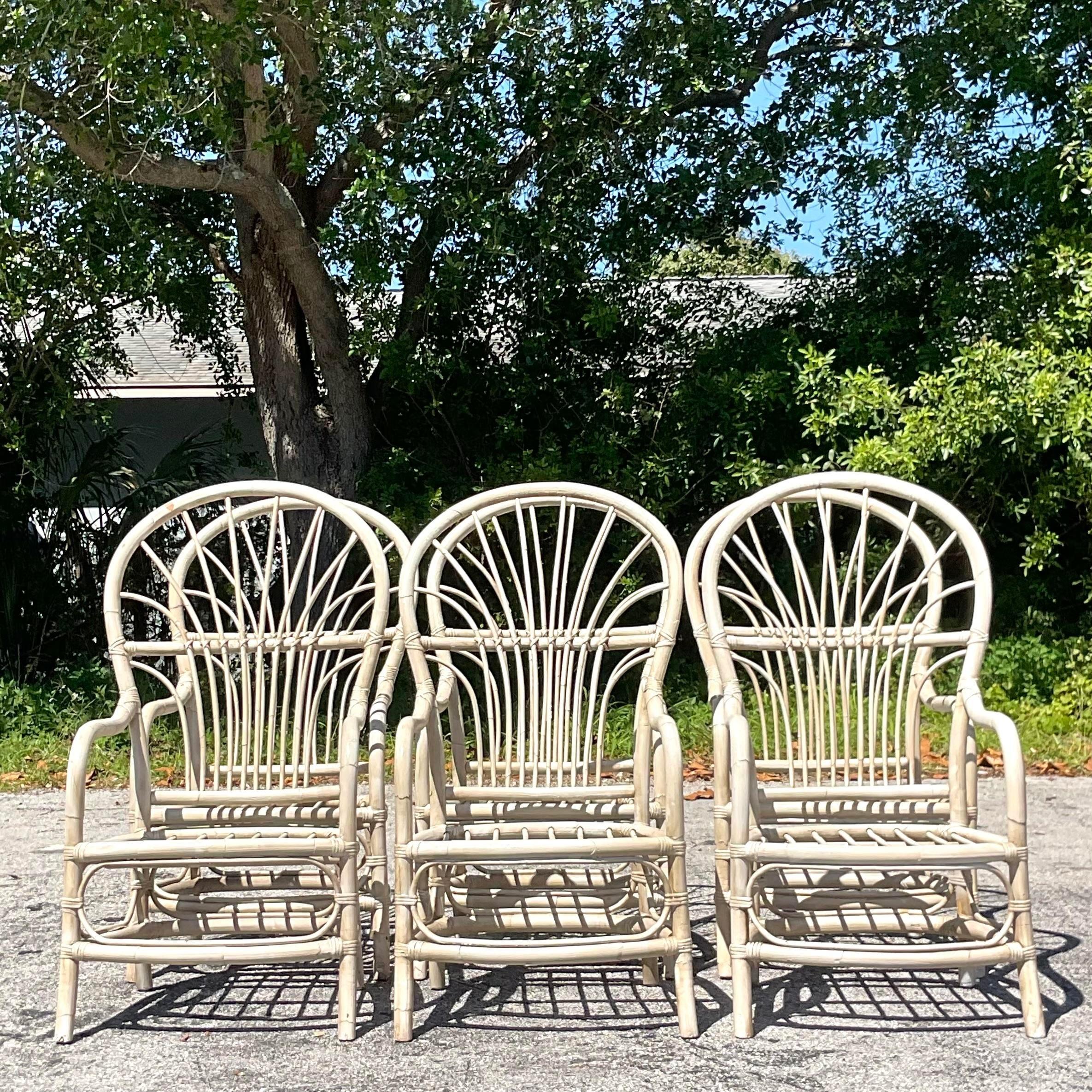 Embrace coastal charm with this set of Vintage High Back Rattan Dining Chairs. Infused with American style, these chairs evoke a sense of relaxed elegance with their classic design and natural rattan construction. Perfect for gatherings and everyday