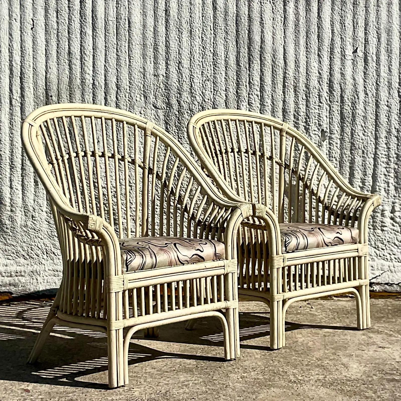 A fabulous pair of vintage costal lounge chairs. Chic arched backs in a painted off white finish. Perfect as is or paint to suit your project. Acquired from a Palm beach estate.