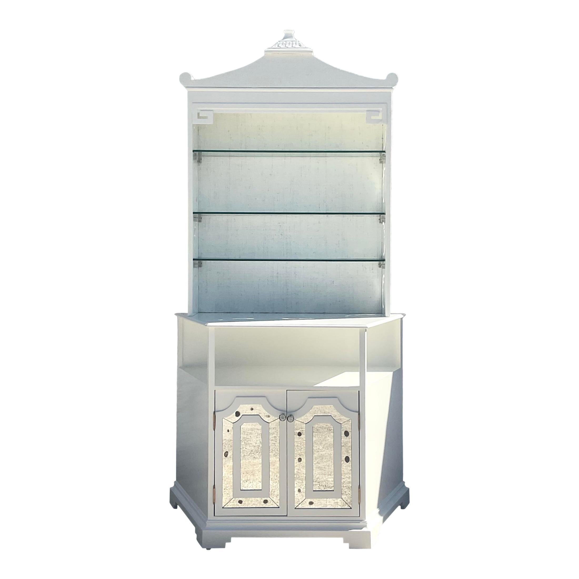 An incredible vintage custom built high gloss white pagoda bar. Monumental in size and drama. A fresh white lacquer and mirrored glass details make this piece a real sparkling diamond. Grasscloth touches throughout the piece. Hails from the estate
