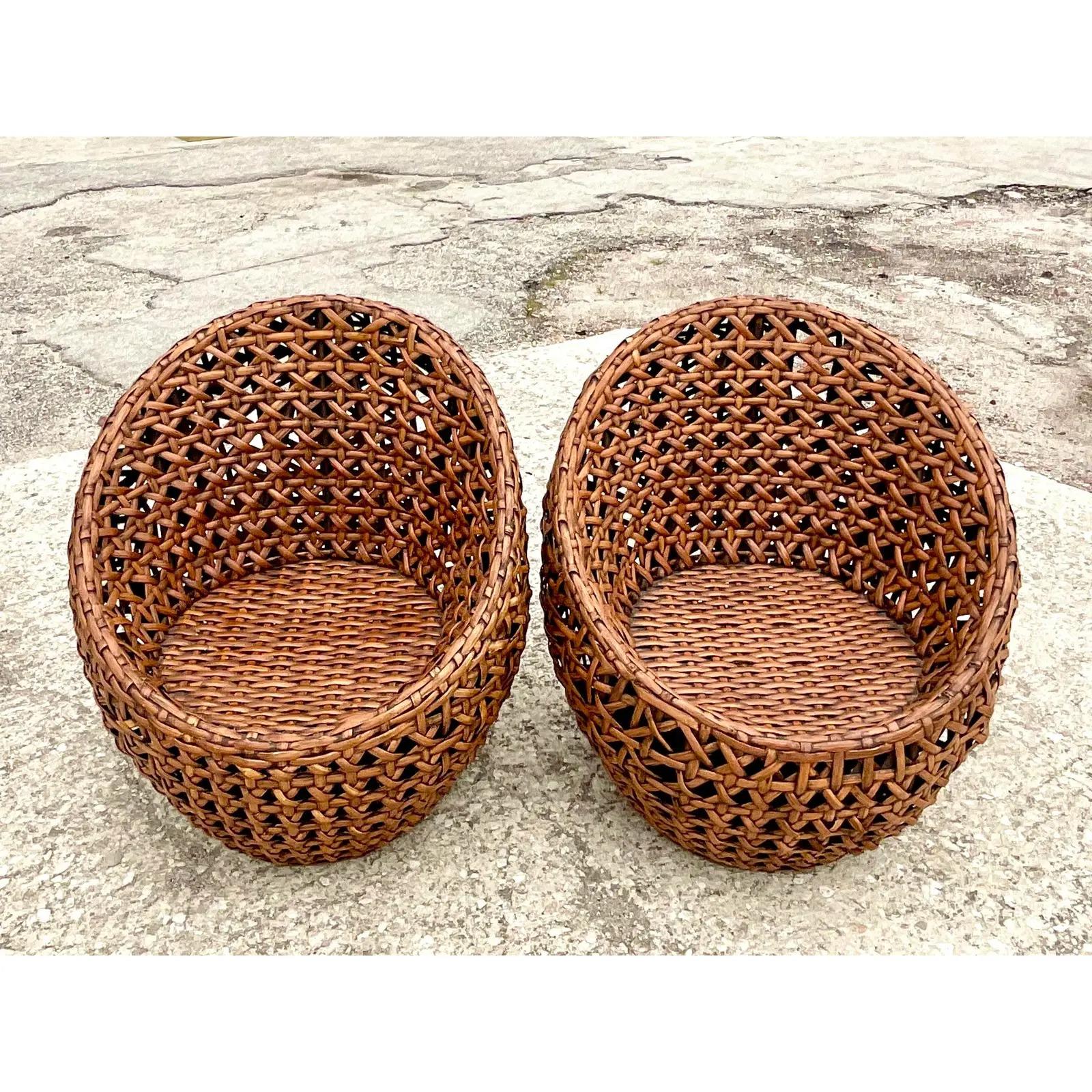 Fantastic pair of vintage Coastal lounge chairs. Beautiful honeycomb woven rattan in a chic pod shape.. Acquired from a Palm Beach estate.