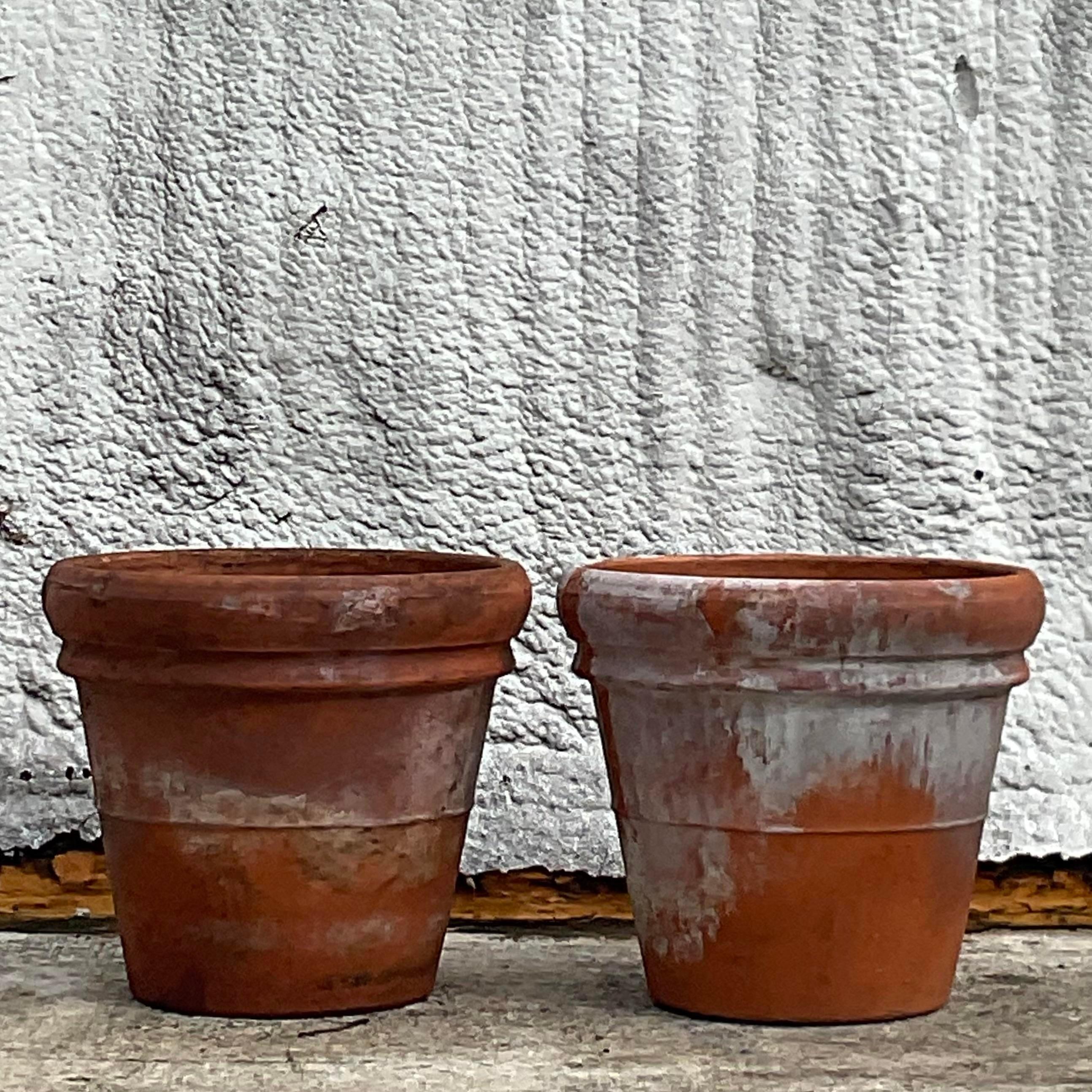 A fabulous pair of vintage Coastal planters. A chic Italian terra Cotta with a beautiful all lover patina from time. Acquired from a Palm Beach estate.