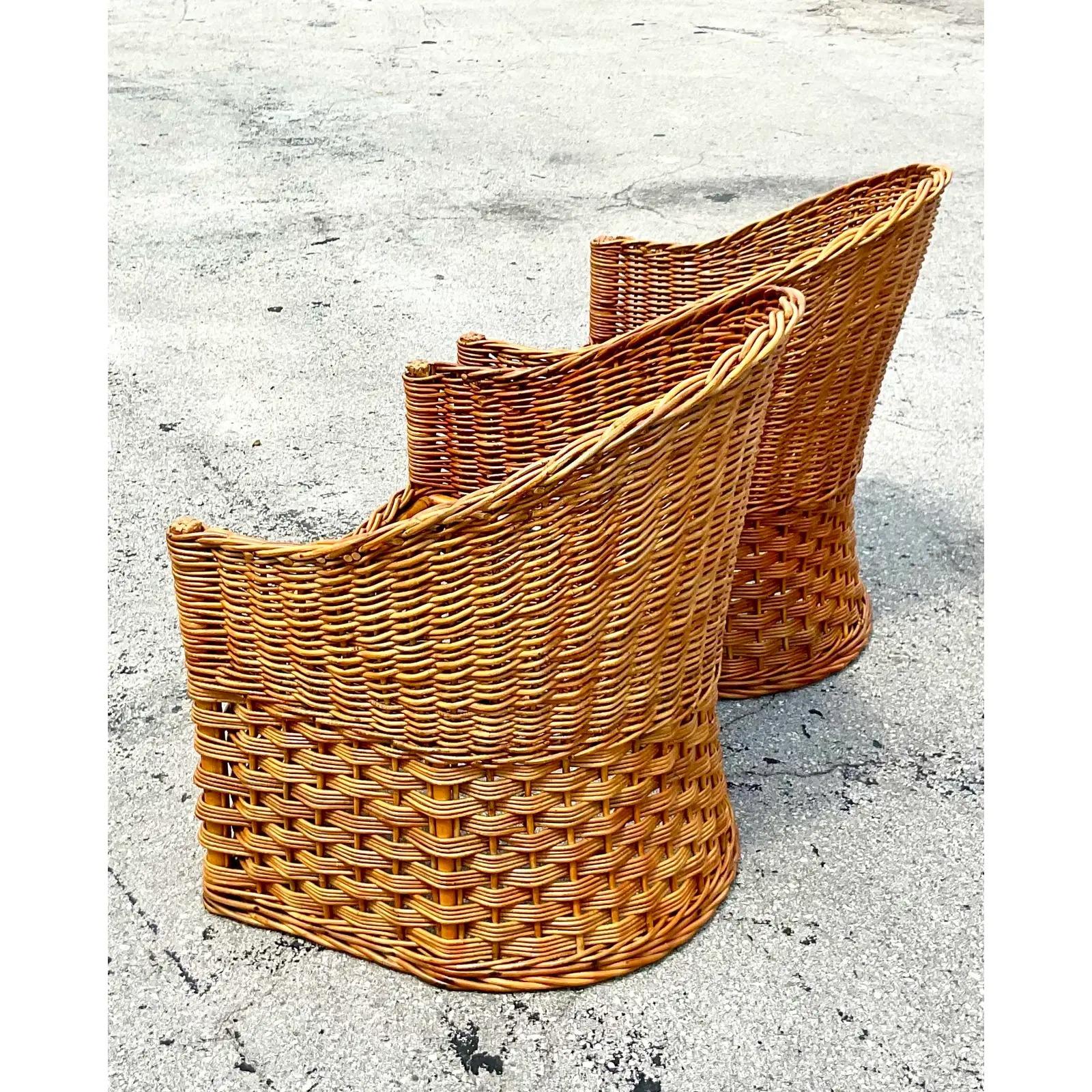 A stunning pair of vintage Coastal tub chairs. Beautiful woven rattan made by the Wicker Works group in Italy. Chic and clean shape. Acquired from a Palm Beach estate.