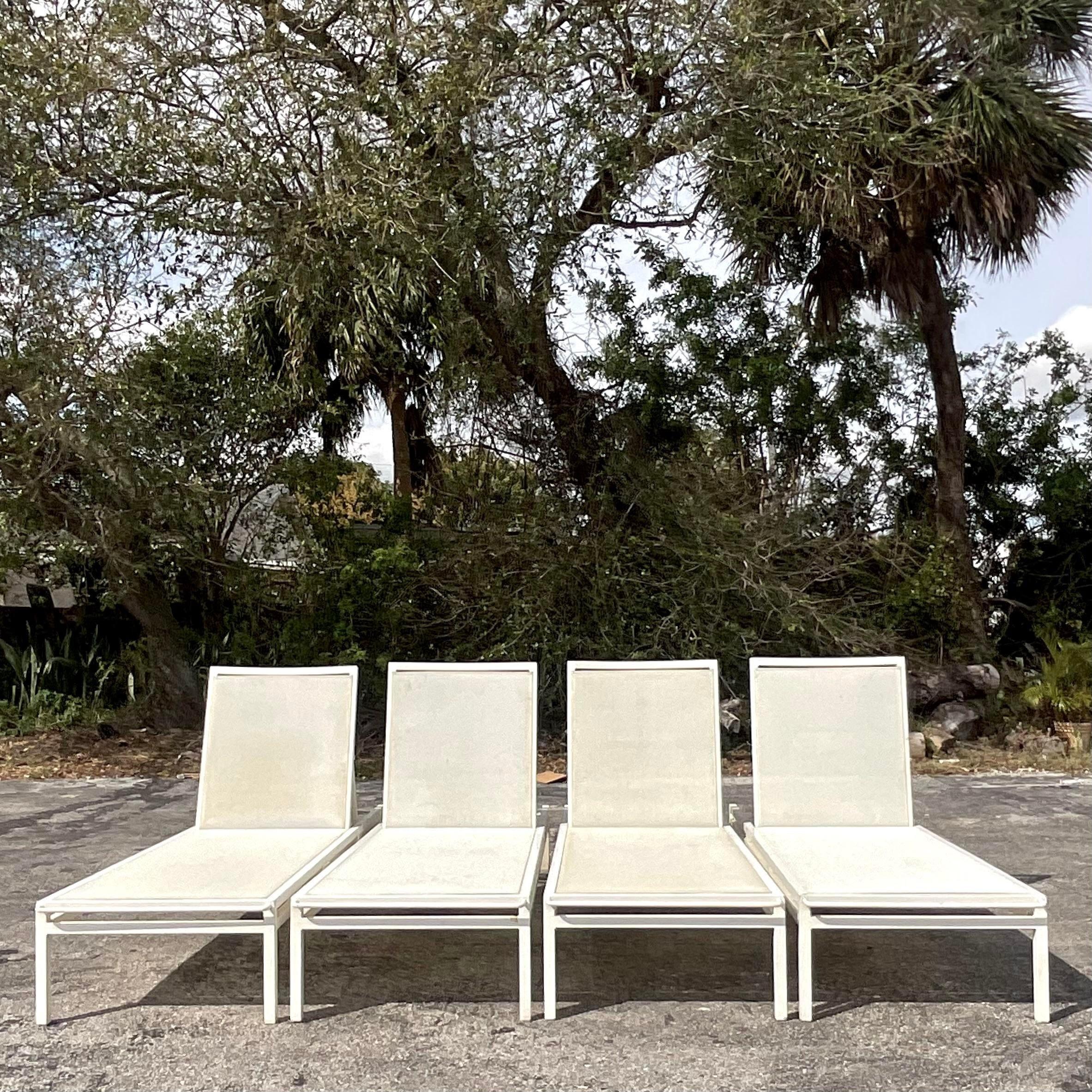 A fabulous pair of vintage Coastal chaise lounge chairs. Made by the iconic Janus et Cie and tagged on the back. A chic cast aluminum frame with a inset mesh seat. Two sets of two available on my page. Acquired from a Palm Beach estate