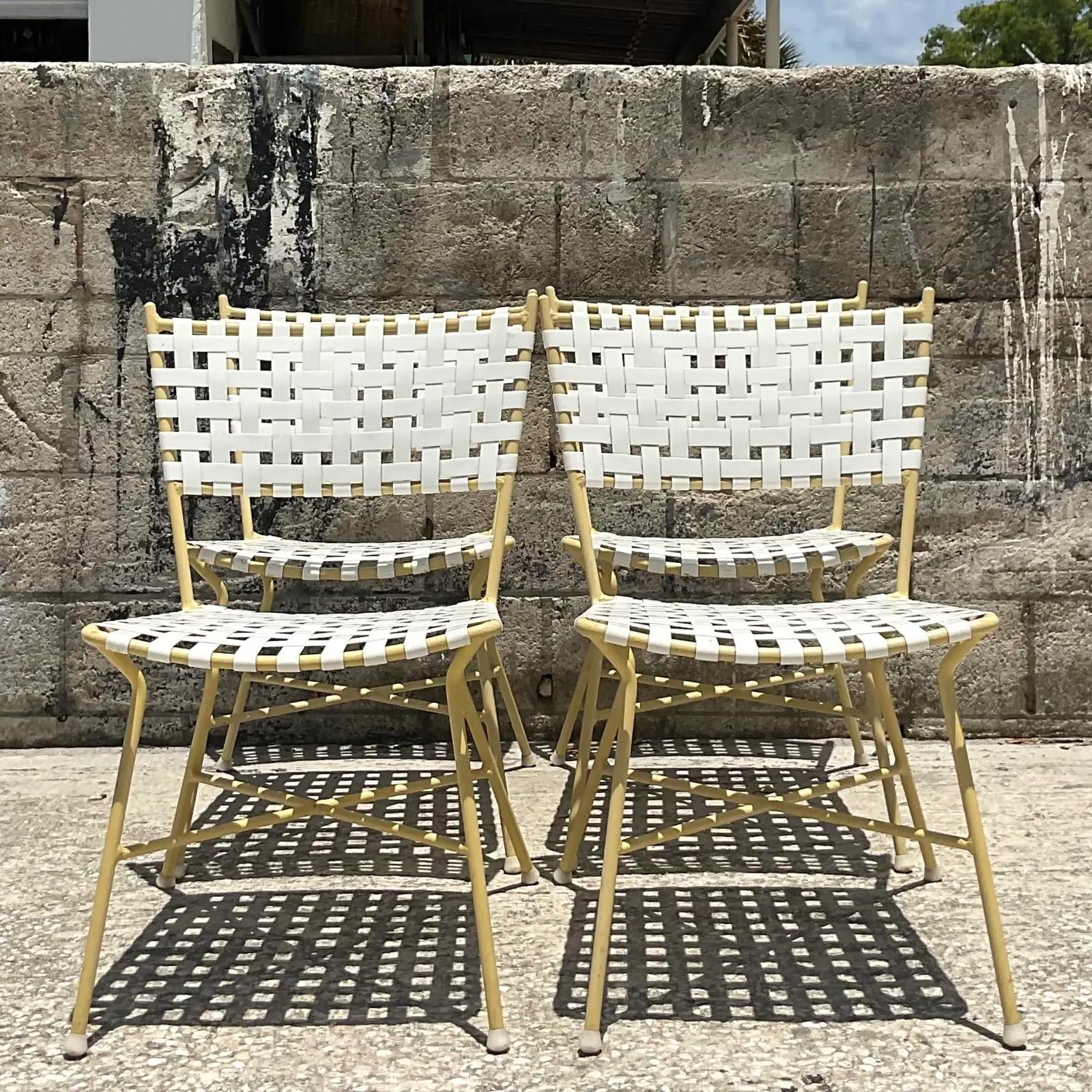 Fantastic set of vintage MCM outdoor dining table and chairs. Chic clean shape with vinyl strapping. Coordinating lounge chairs and tables also available. Acquired from a Miami estate.