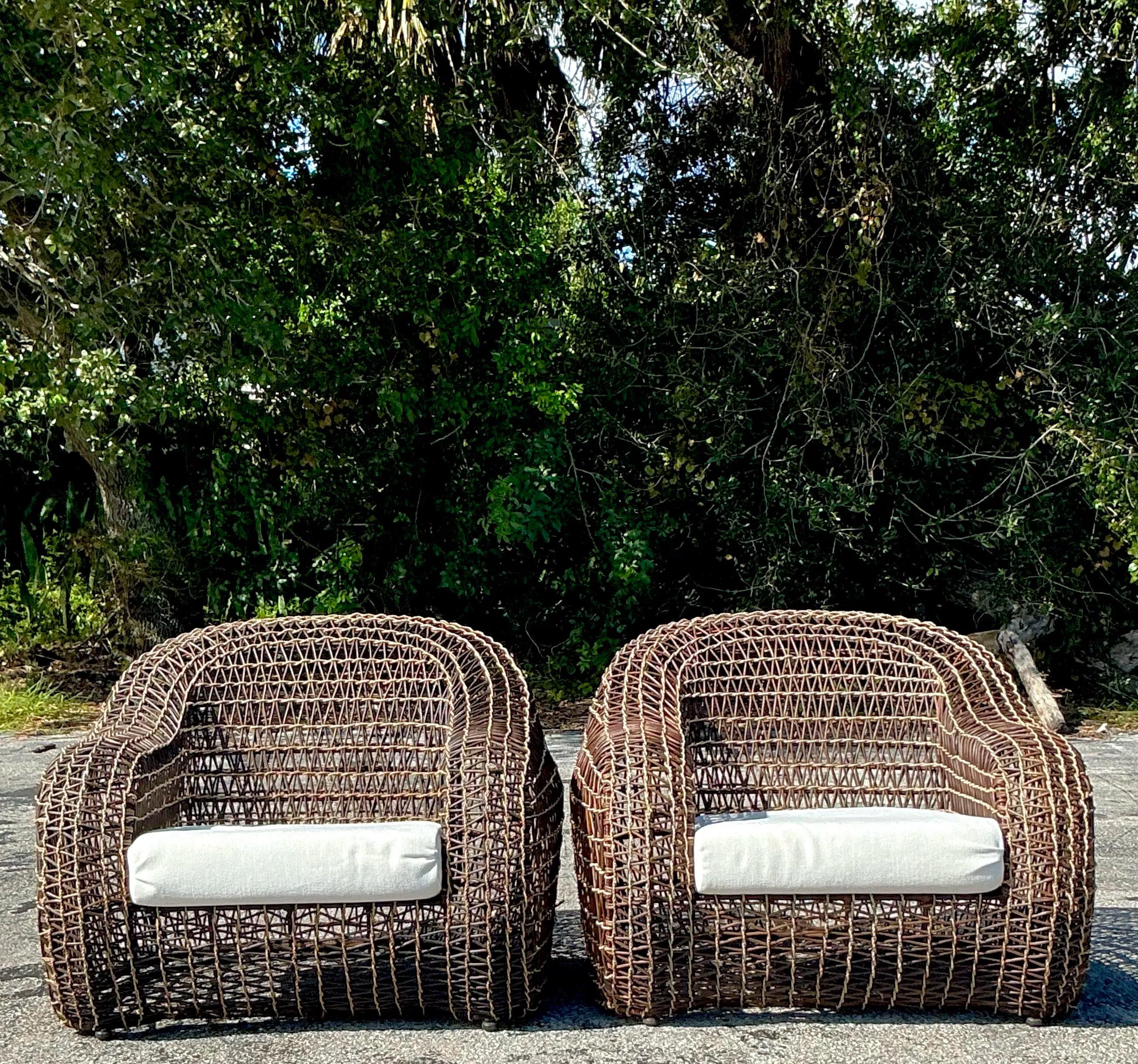 Add a touch of relaxed coastal elegance with this pair of Kenneth Cobonpue lounge chairs. Crafted from woven rattan and jute, these chairs bring a breezy, natural vibe that's perfect for any boho or beach-inspired space. With their iconic design and