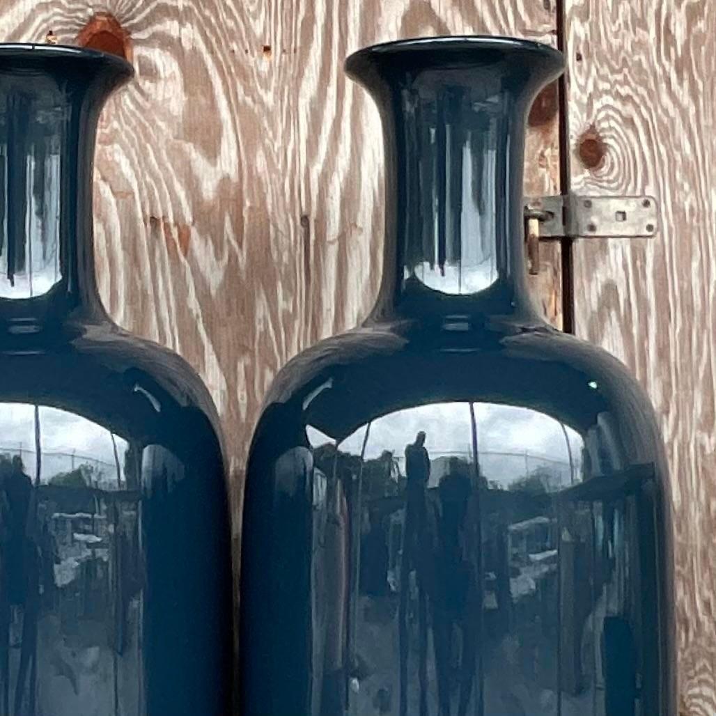 A fabulous pair of vintage Coastal floor vases. A chic navy blue lacquered bamboo in a high gloss finish. An easy way to add a flash of drama to any space. Acquired from a Palm Beach estate.
