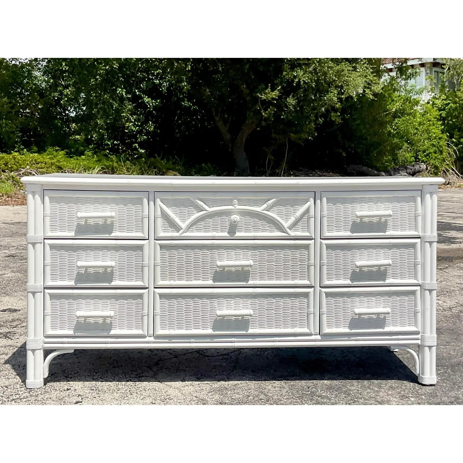 Fantastic vintage Coastal dresser. Made by the iconic Henry Link group. Beautiful white lacquered finish over a carved bamboo design. Acquired from a Palm Beach estate.