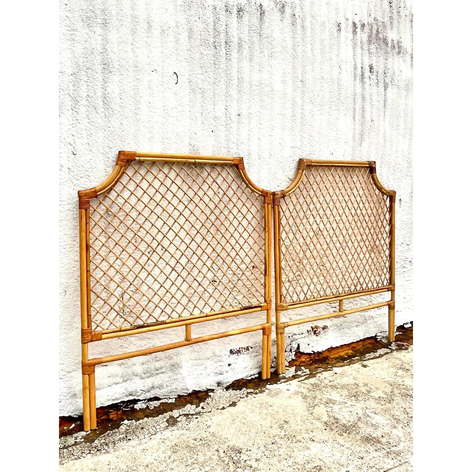 Fantastic pair of vintage bamboo and rattan twin headboards. A beautiful pagoda shape with a chic lattice work detail. Acquired from a Palm Beach estate.