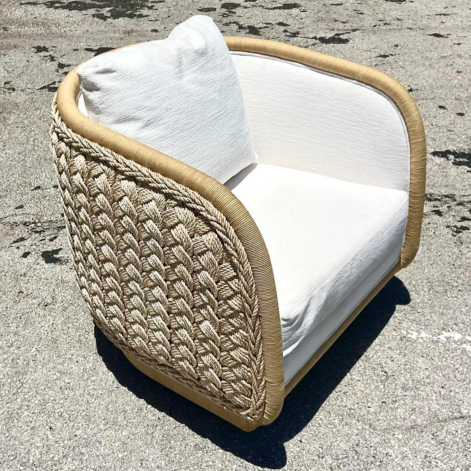 An incredible vintage Coastal swivel chair. Designed by Laura Kirar. Beautiful braided rattan in a tub shape. Beautiful bright with its upholstery. Acquired from a Palm Beach estate.