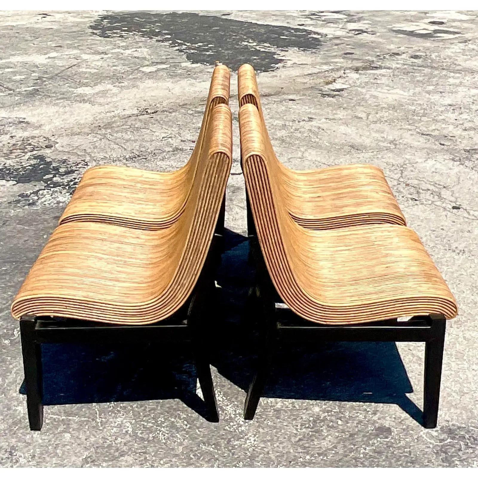 Fabulous set of four Coastal dining chairs. Beautiful light pencil reed in a chic contemporary shape. This set of slightly lighter in color than the other set that is available on my page. Acquired from a Palm Beach estate.