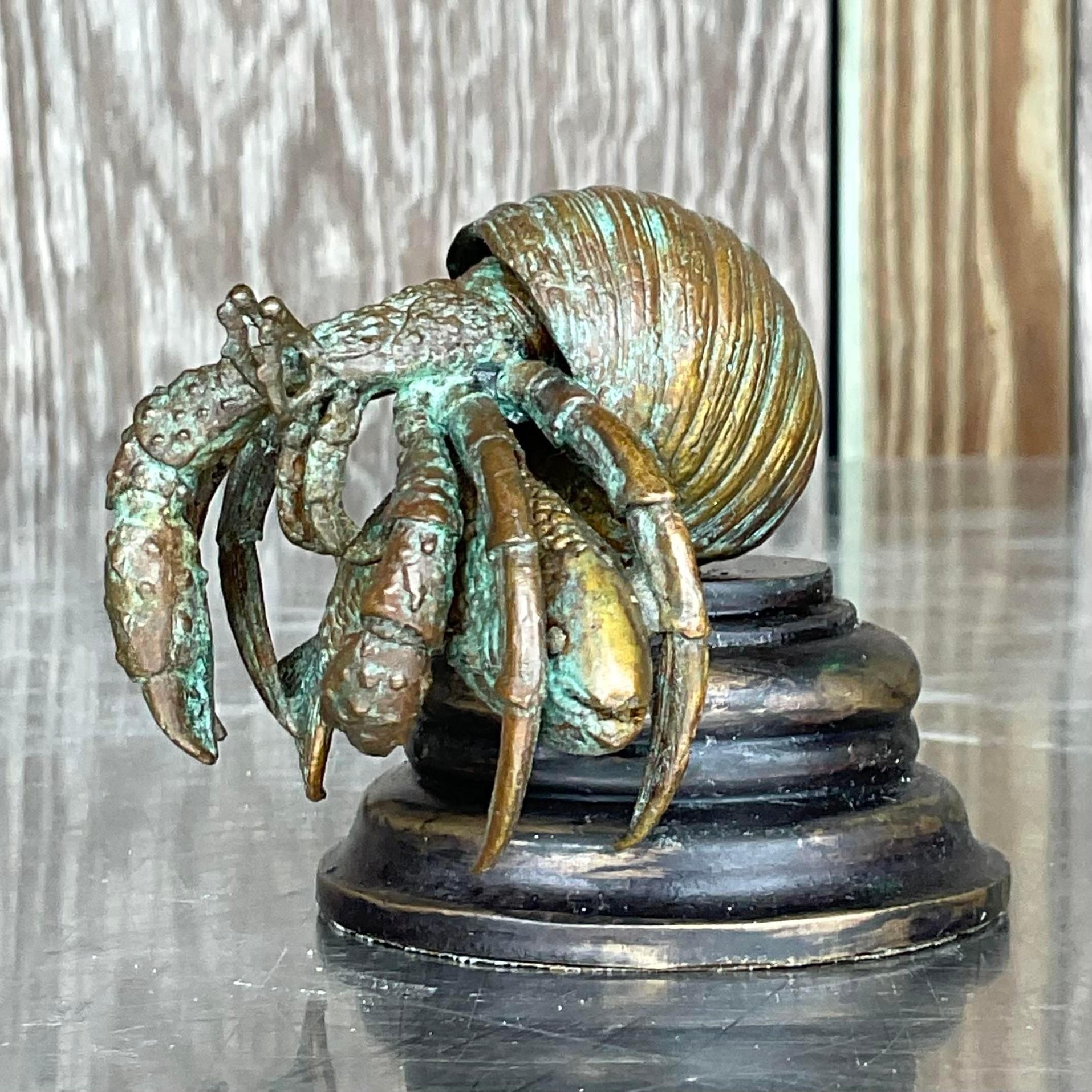 A fantastic vintage Coastal hermit crab. A chic patinated bronze crab on a milled wooden plinth. Made by the iconic Maitland Smith group and tagged on the bottom. Acquired from a palm Beach estate.