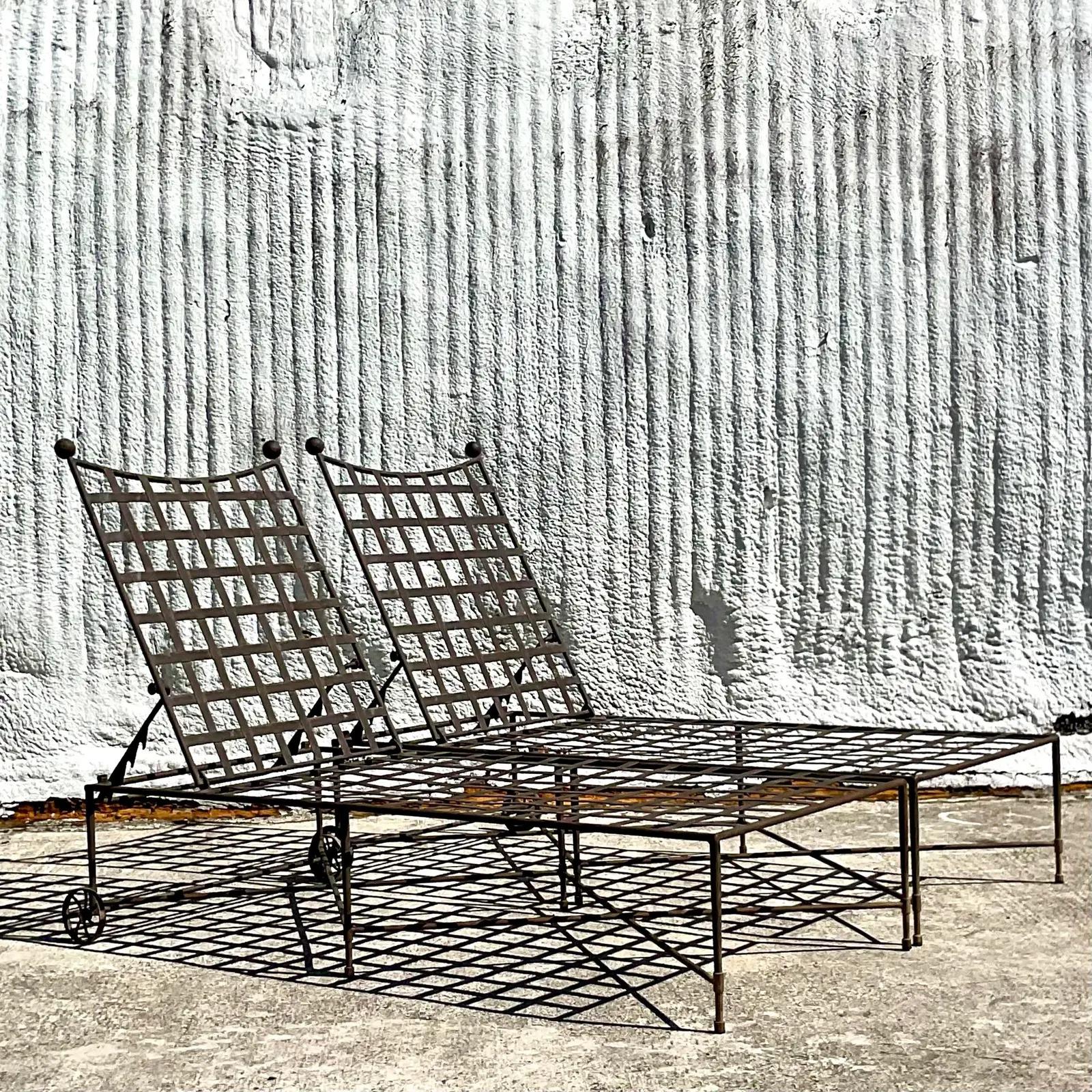 A fabulous set of two Coastal chaise Lounge chairs. Designed by the iconic Mario Papperzini for Salterini. Beautiful wrought iron grid design with the signature spheres at each end. Unmarked. Three pairs total available for a possible total of 6.