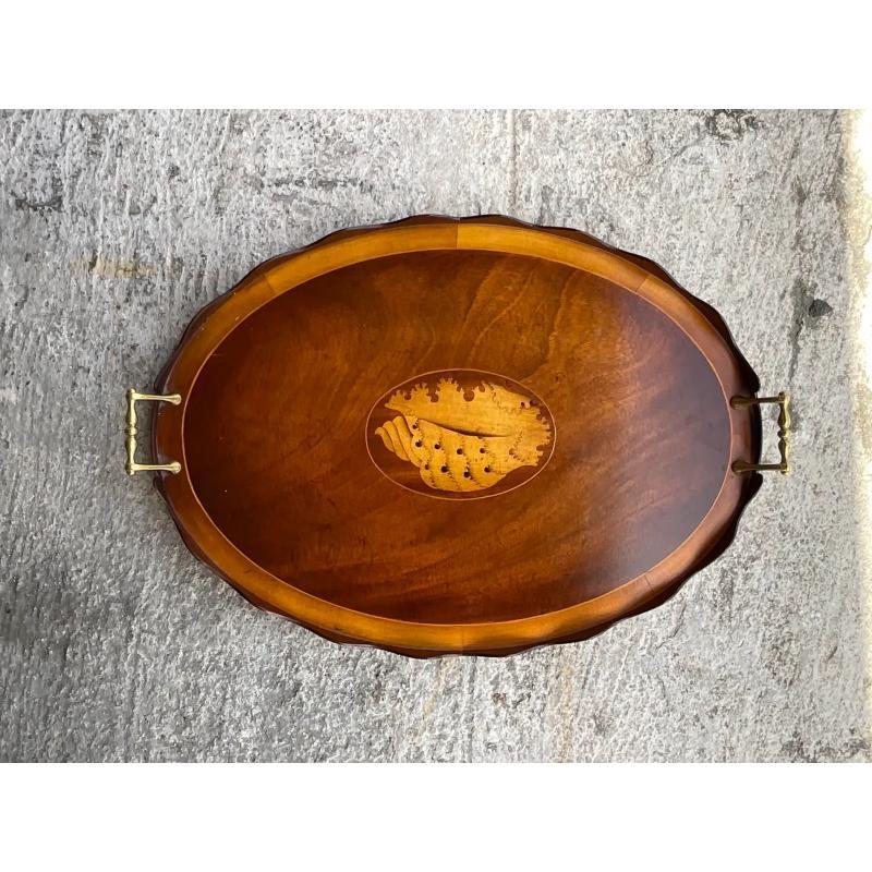 A stunning vintage Coastal tray. A chic marquetry construction with brass hardware. An amazing shell design inlaid into the center. Acquired from a Palm Beach estate.