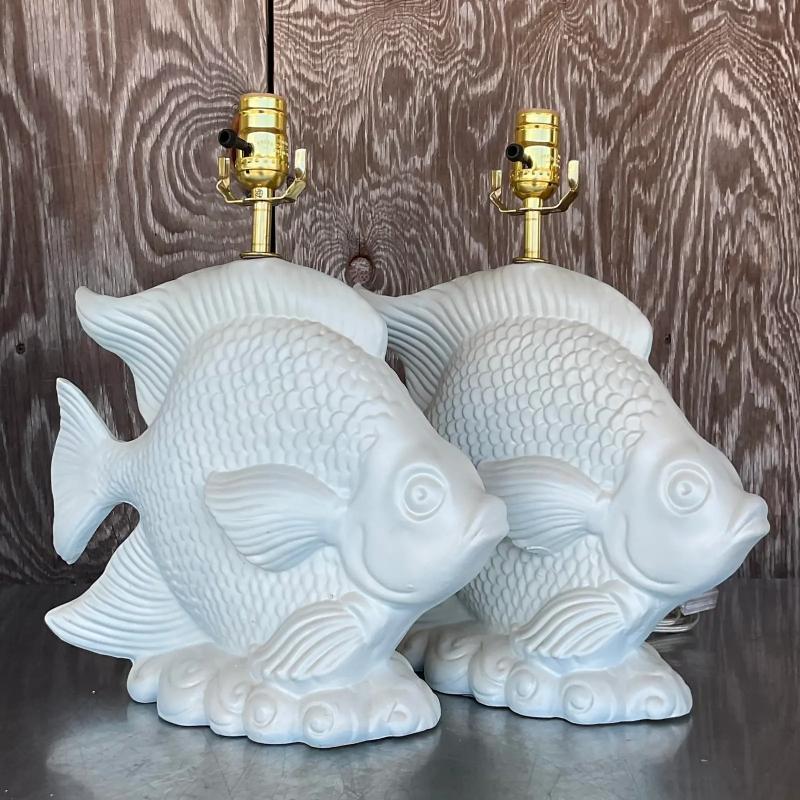 A stunning pair of vintage Coastal table lamps. Happy little fish in a matte white finish. Fully restored with all new wiring and hardware. Acquired from a Palm Beach estate