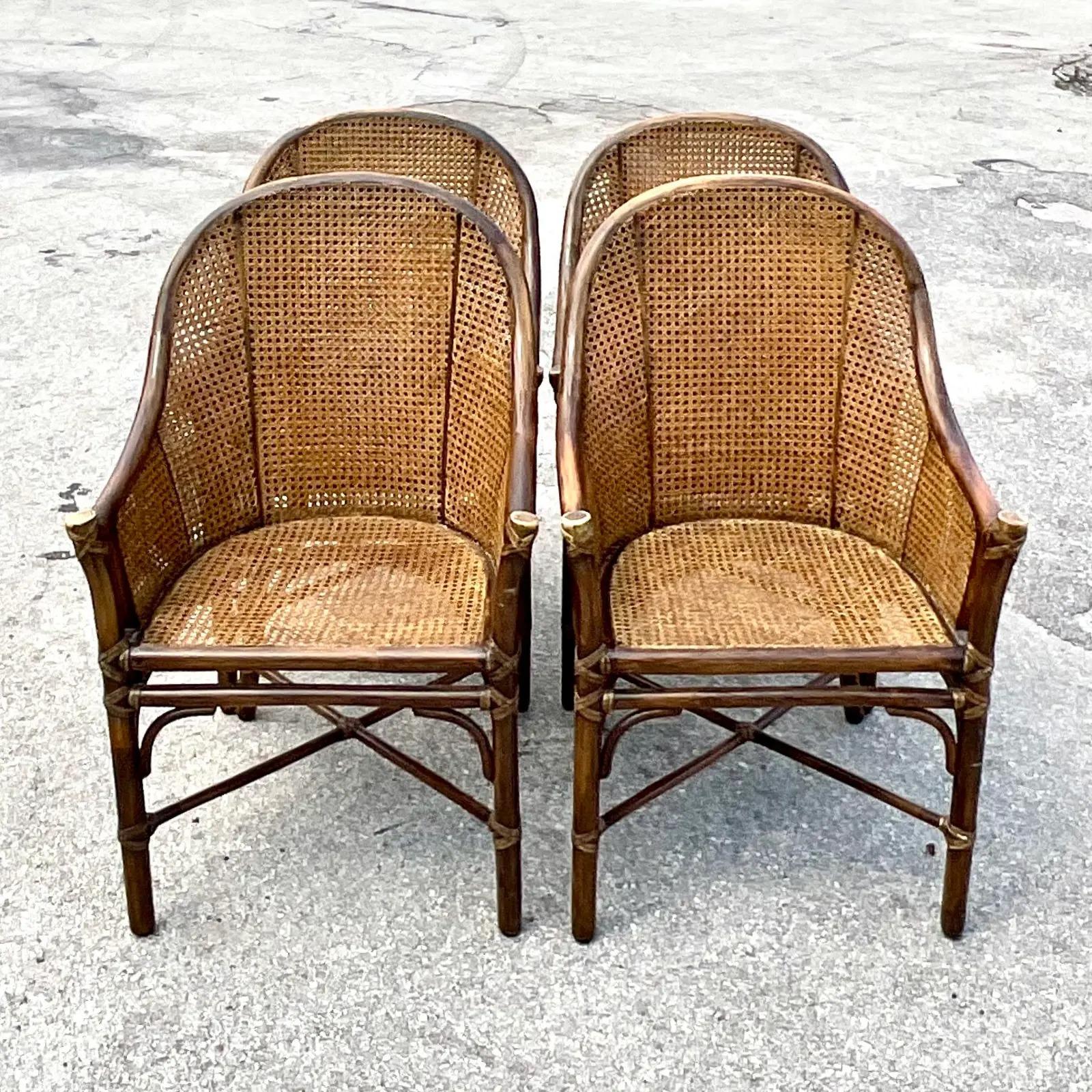 Incredible set of four vintage Cane dining chairs. Made by the iconic McGuire company. Chic and simple rattan high back frame with honeycomb caning. The most beautiful patina from time. Acquired from a Palm Beach estate.