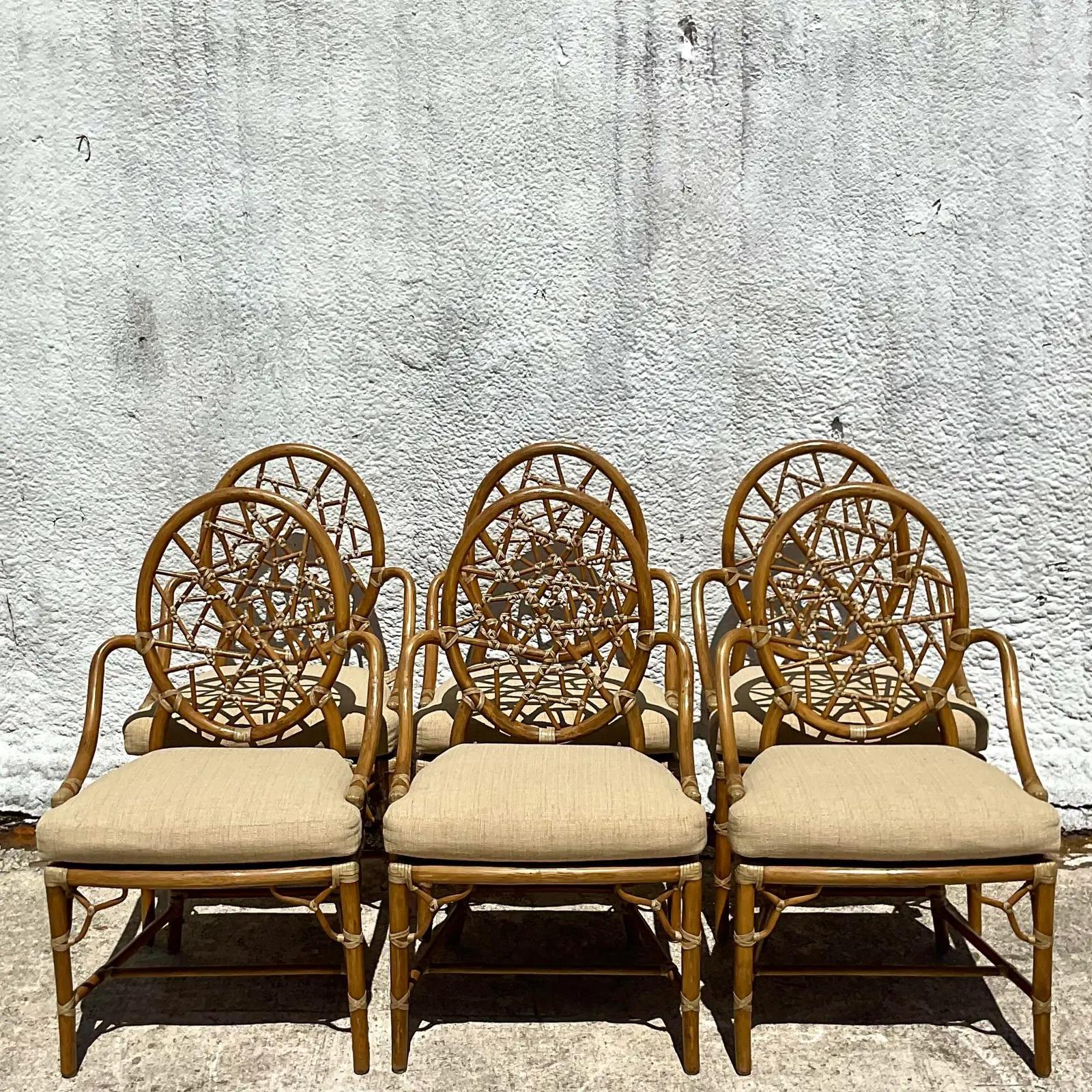 Spectacular set of 6 vintage Coastal dining chairs. The coveted “Cracked Ice” design made by the iconic McGuire Group. Beautiful bent rattan chair with inset cane seats. Custom cushions with all logo tags in tact. In pristine condition. Acquired