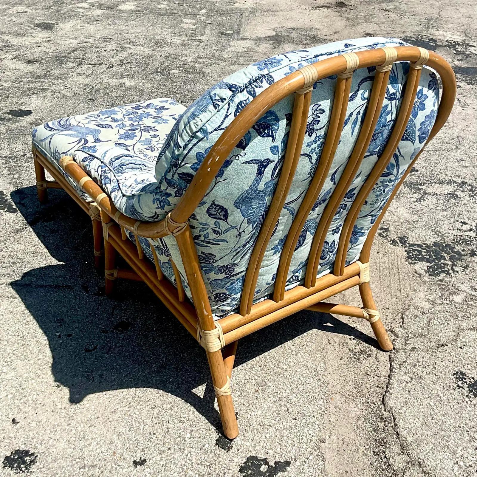 Fabulous vintage Coastal lounge chair and ottoman. Made by the iconic McGuire of San Fran group. Luxurious down cushions for extra comfort. Beautiful printed bird printed cotton in shades of blue. Acquired from a Palm Beach estate.

Measure: