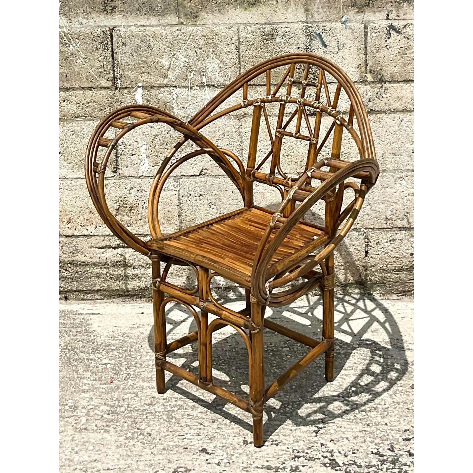 Fantastic vintage Coastal rattan chair. Made by the iconic McGuire group and tagged on the bottom. The coveted butterfly design with high arms and fluid movement. Acquired from a Palm Beach estate.