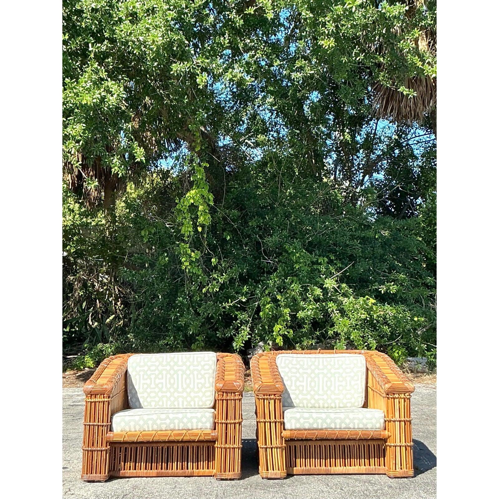 Embrace the relaxed elegance of coastal living with this exquisite pair of vintage McGuire rattan club chairs. Featuring a bold, sculptural design with meticulously handwoven rattan, these chairs offer an inviting mix of organic texture and timeless