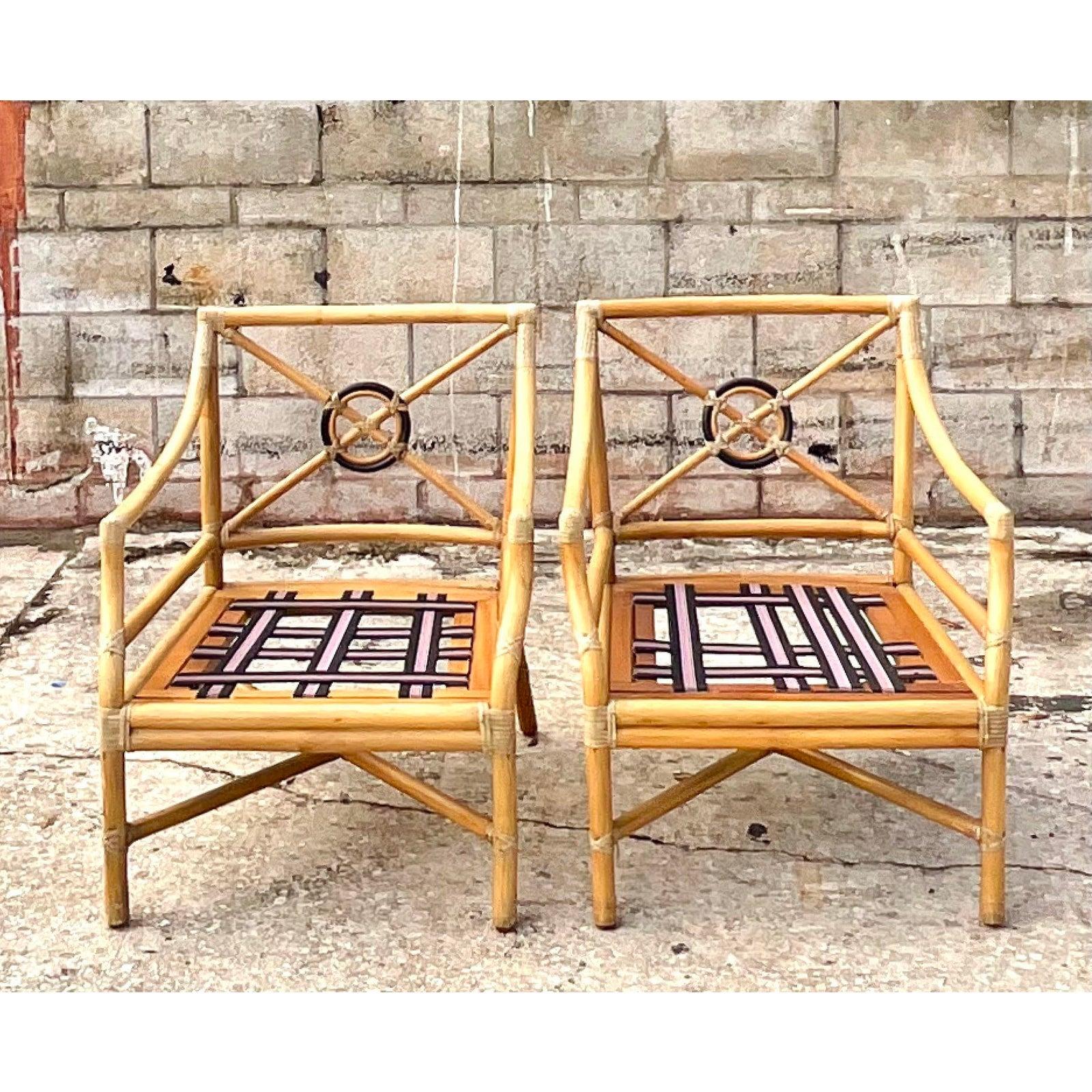 Gorgeous pair of vintage McGuire lounge chairs. The iconic Target Back design with the McGuire logo on the bottom. Deep seats for extra relaxation. Acquired from a Palm Beach estate.