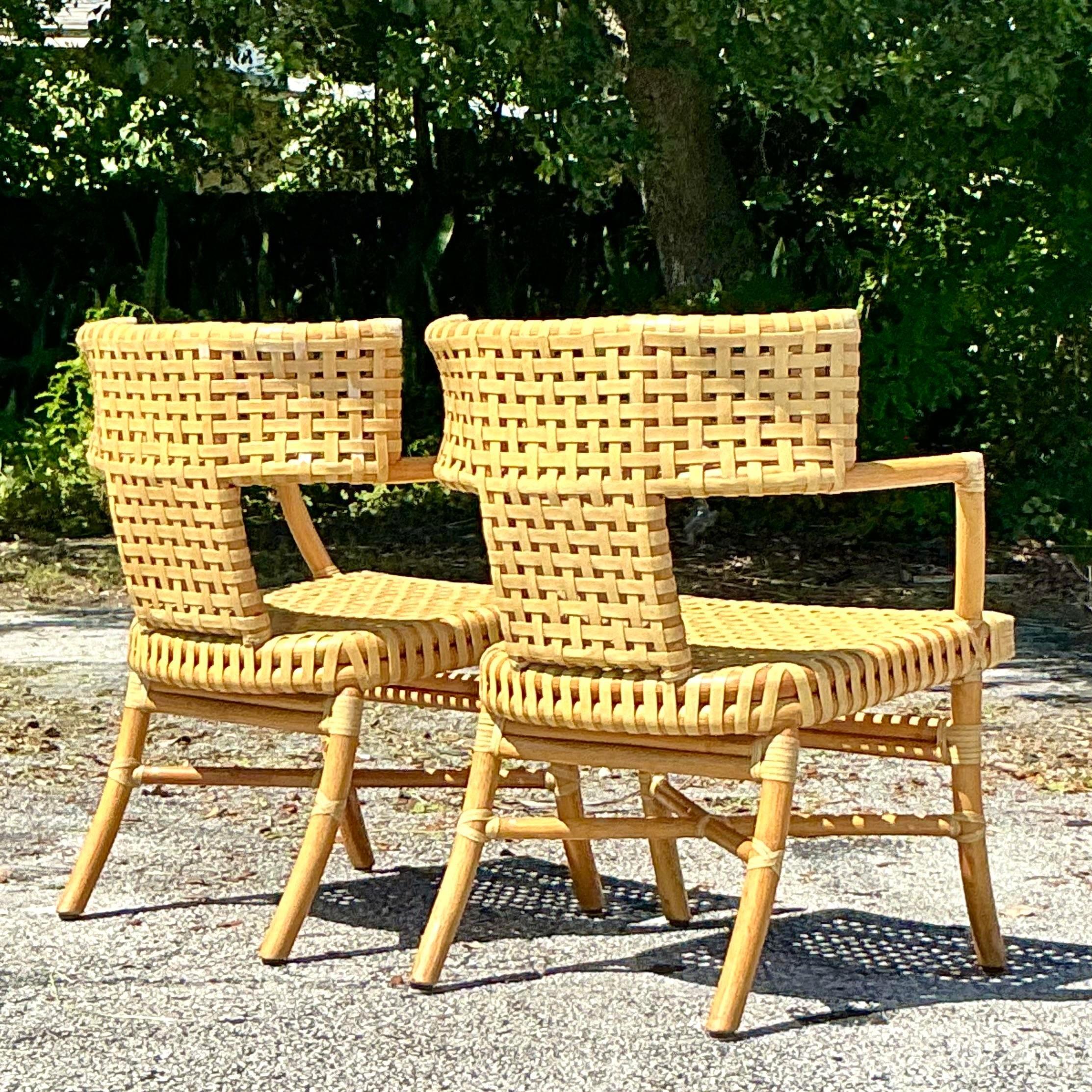 Add timeless coastal charm to your home with this pair of Vintage McGuire Woven Leather Klismos Chairs. These expertly crafted chairs feature the iconic Klismos silhouette, known for its elegant curved back and tapered legs, combined with McGuire’s