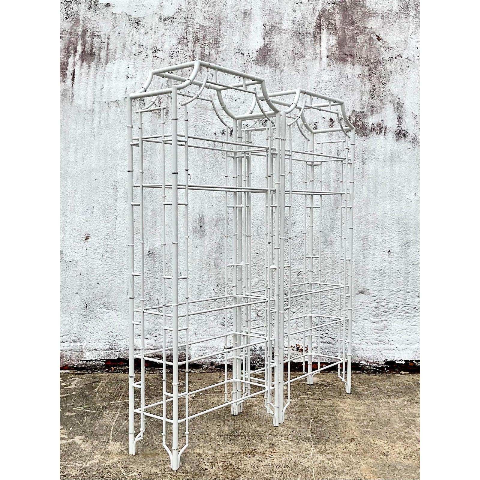 Fantastic pair of vintage pagoda etagere. Bright white metal in a bamboo design. Inset glass shelves. A chic addition indoors or outside in a covered area. Acquired from a Palm Beach estate.
