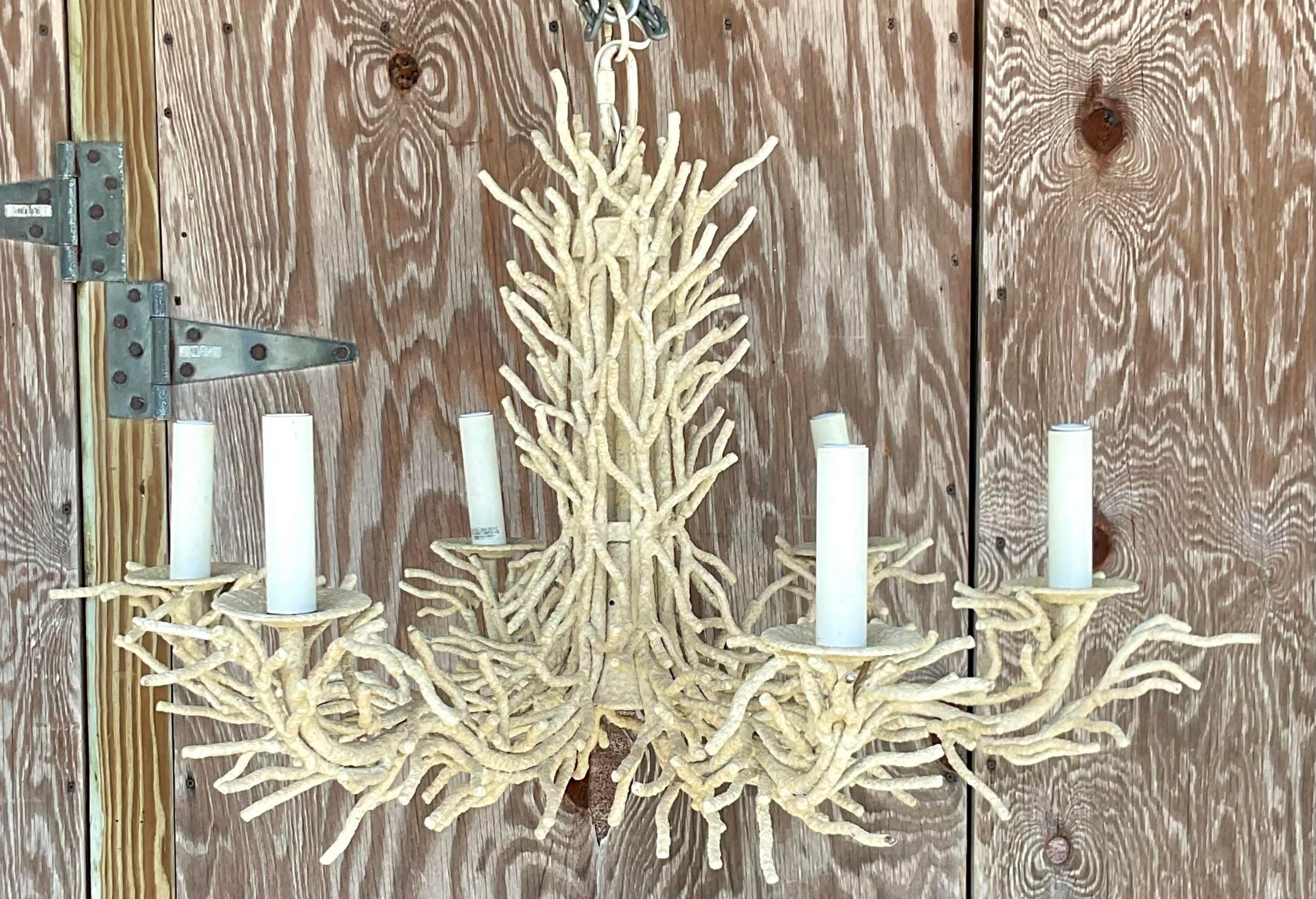 A vintage coastal painted metal chandelier. The coveted coral brand design in a six arm design. Perfect as is or paint to match your project. Acquired from a Palm Beach estate.