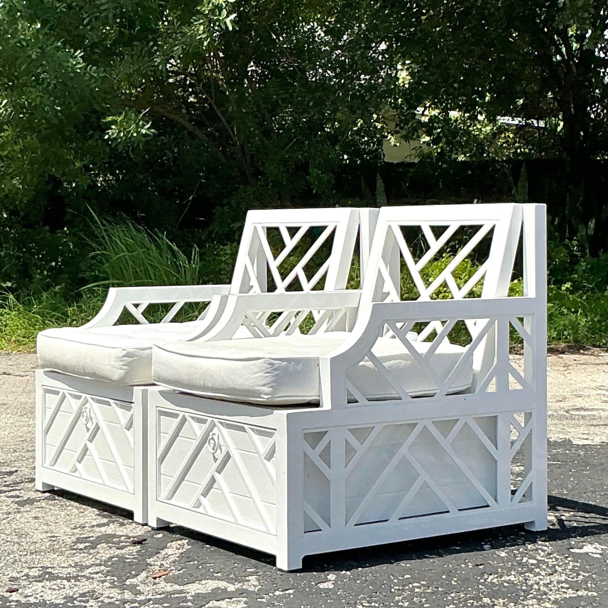Bring a touch of vintage coastal charm to your space with this exquisite pair of Miles Redd for Ballard Design Chinese Chippendale Lounge Chairs. These chairs feature the iconic Chippendale latticework design, with a modern coastal twist, blending