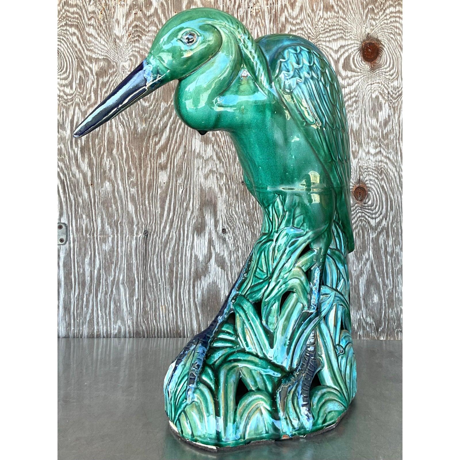 Gracefully poised and richly detailed, this vintage monumental glazed ceramic heron brings a captivating coastal elegance to any space. Hand-sculpted in a lush palette of seafoam, emerald, and navy blue, the heron features intricate feather and