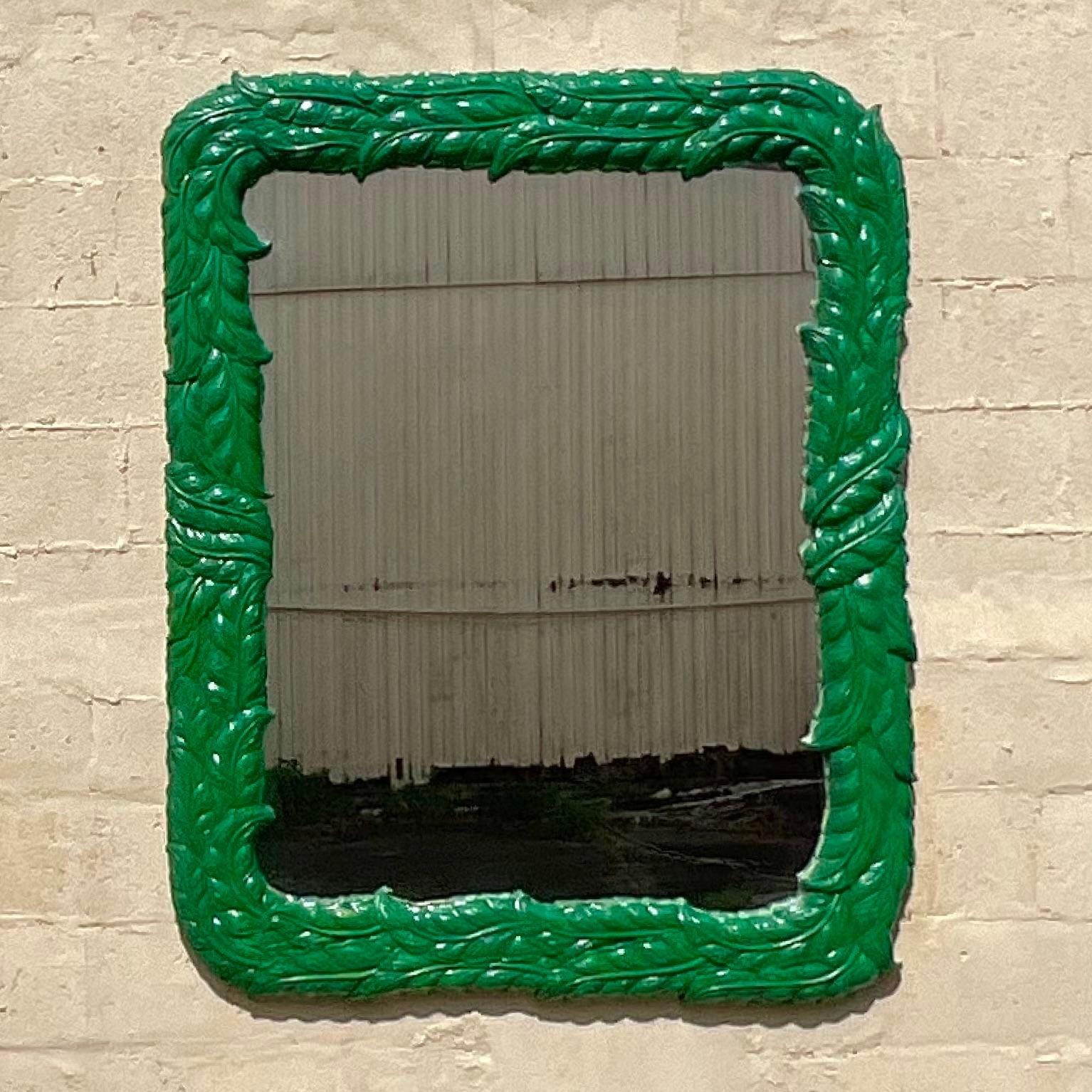 A stunning vintage Coastal wall mirror. A chic molded frame in a glamorous palm frond design. Painted a brilliant Kelly green. Acquired from a Palm Beach estate.