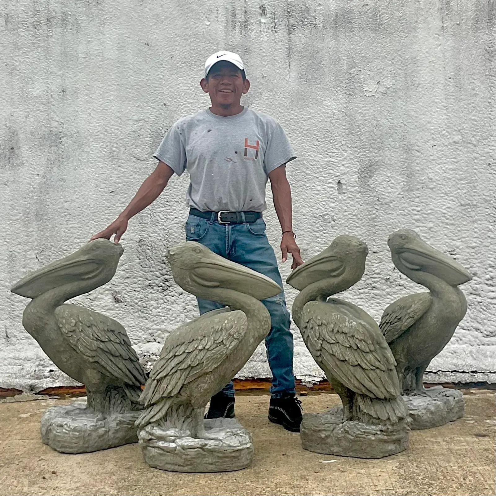 A fantastic pair of vintage Coastal Statues. A chic pair of handsome pelicans in cast concrete. Perfect poolside or on your dock. You decide! Great in their current color or paint them white for the Palm Beach look. Two pairs available. Acquired