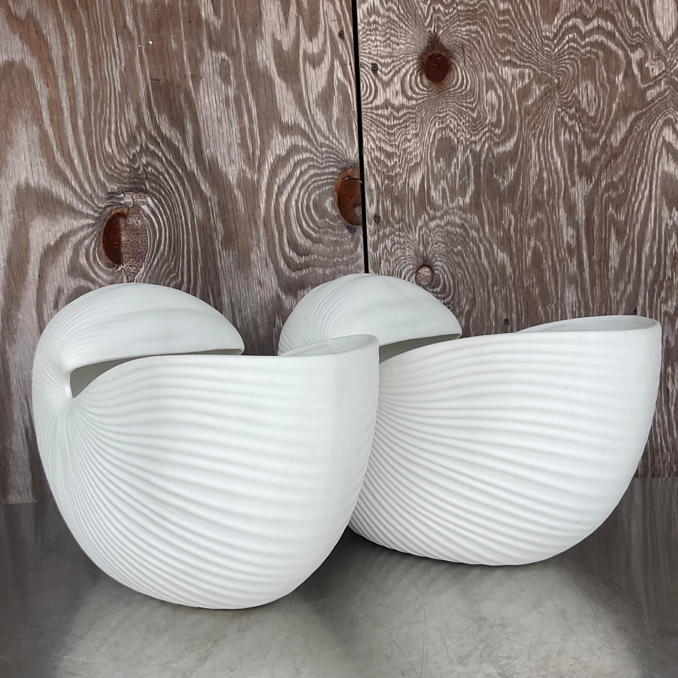 A fabulous pair of vintage monumental matte Ceramic Cachepot. Chic nautilus shell design with a beautiful ripple design. Acquired from a Palm Beach estate.