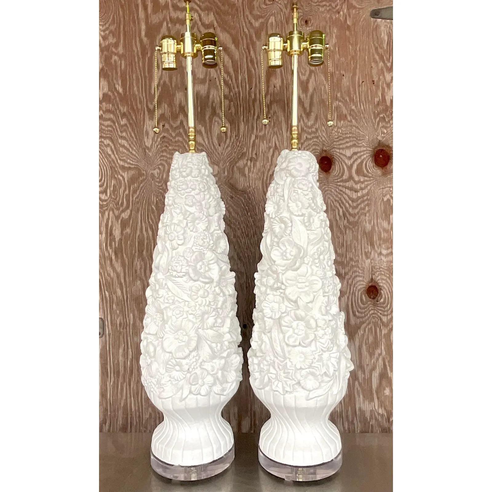 A fantastic pair of vintage Coastal table lamps. A beautiful carved floral design. Fully restored with all new hardware, wiring and lucite plinths. Acquired from a Palm Beach estate.