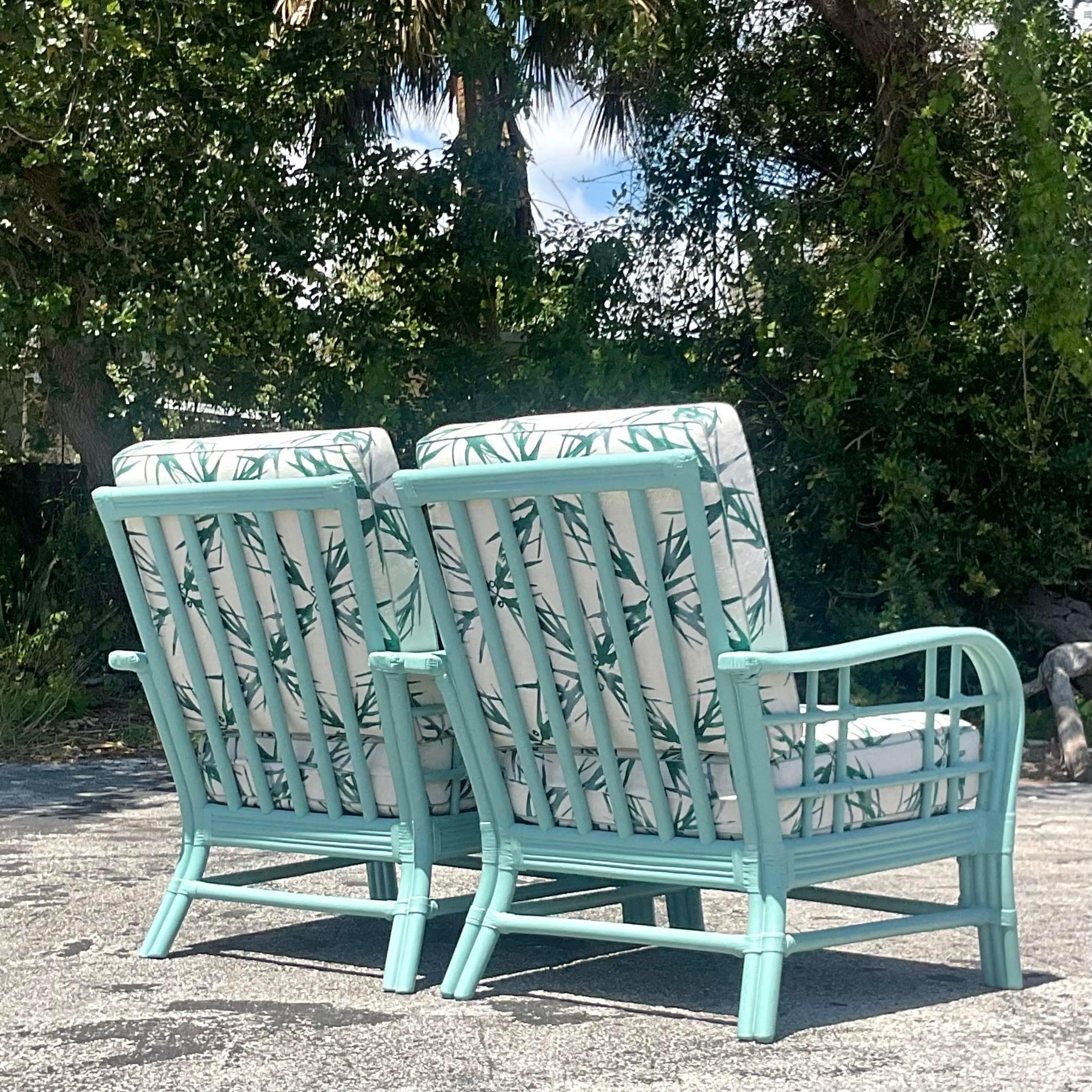 Experience coastal charm with this pair of vintage American-style lounge chairs. Crafted from bent rattan and painted to perfection, they offer a blend of comfort and timeless elegance. Ideal for adding a relaxed, beachy vibe to any space. Acquired