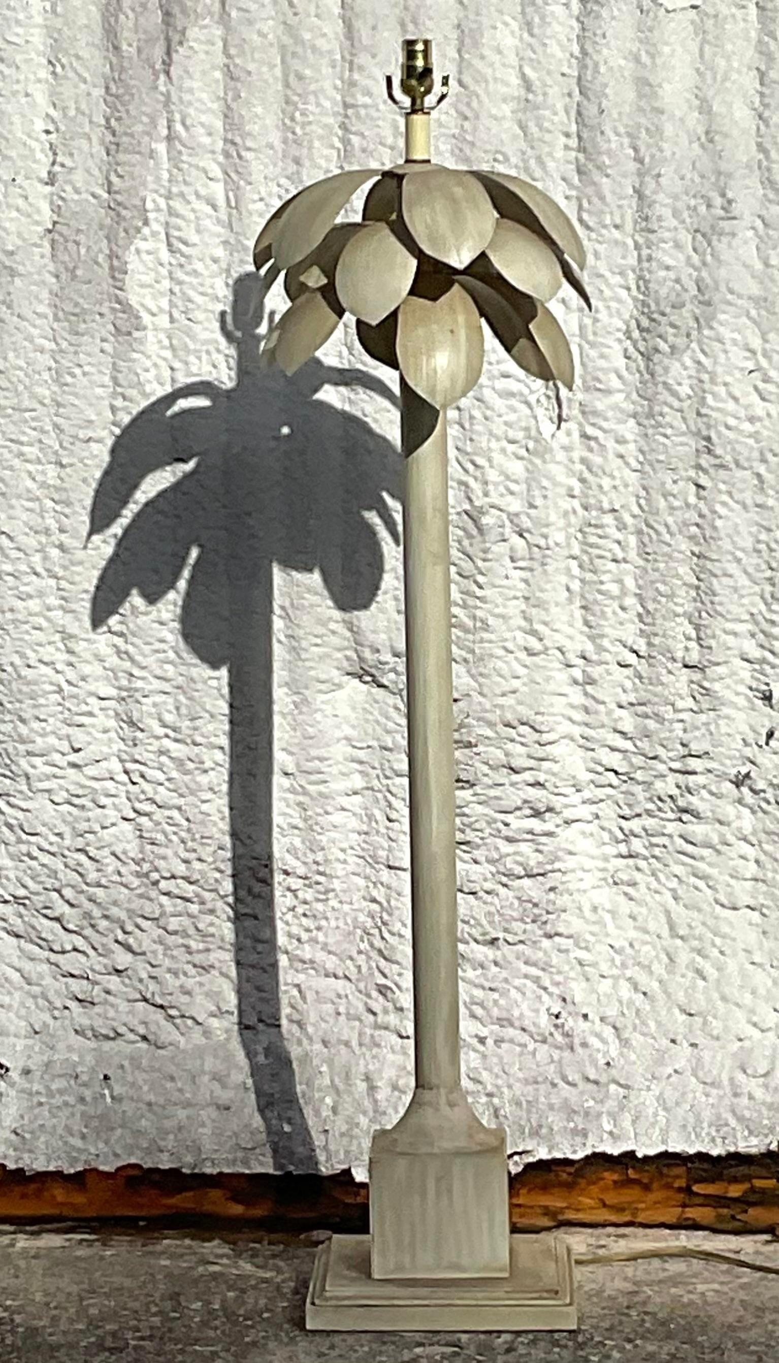 A fabulous vintage Coastal floor lamp. A chic palm tree design with heavy palm fronds at the top. Painted metal frame in an ecru color. Acquired from a Palm Beach estate.