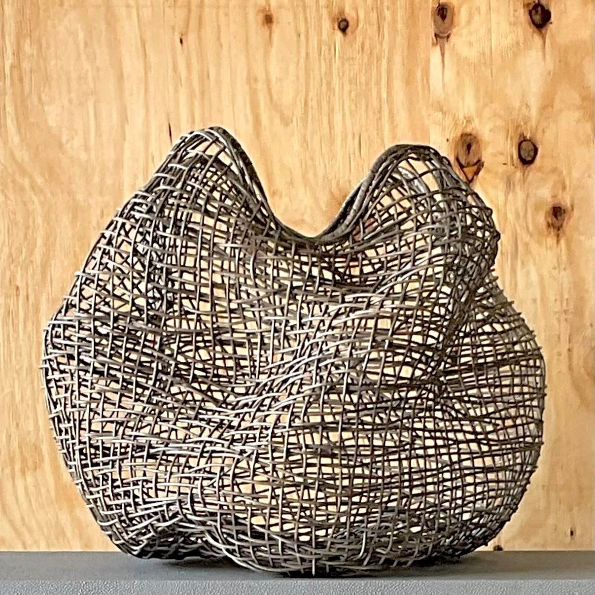 A fabulous vintage Coastal woven biomorphic basket. Made by the Palecek group and named Andora. Acquired from a Palm Beach estate.