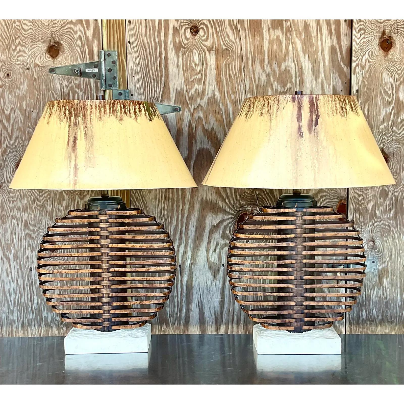 Fantastic pair of vintage Coastal table lamps. Monumental in size and drama. Made by the iconic Palecek with a bamboo cage design. Matching hand painted shades. Rest of faux coral plinths. Acquired from a Palm Beach estate.

The lamps are in great