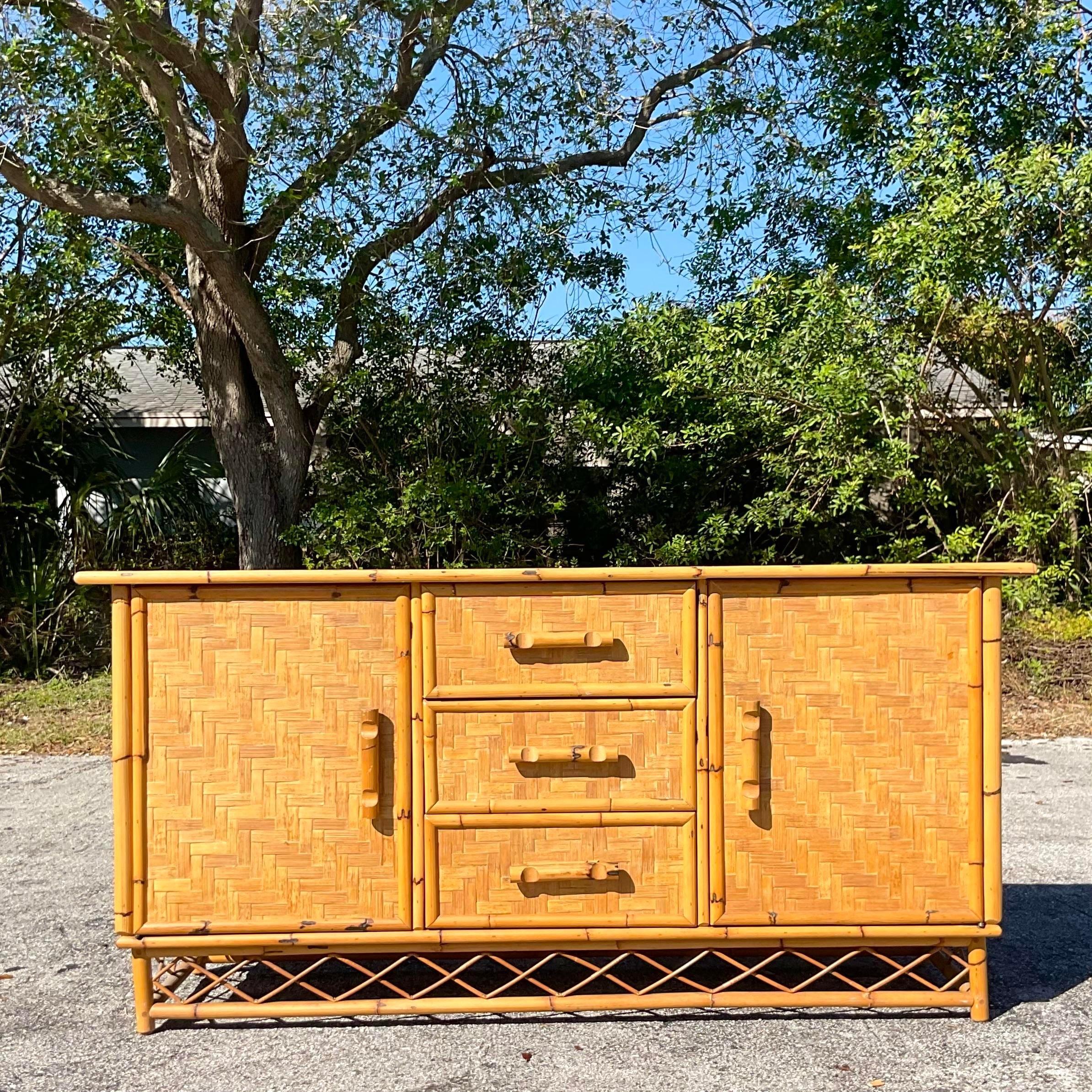 A fabulous vintage Coastal credenza. A chic parquet rattan with trellis rattan detail. Lots of great interior storage. Acquired from a Palm Beach estate
