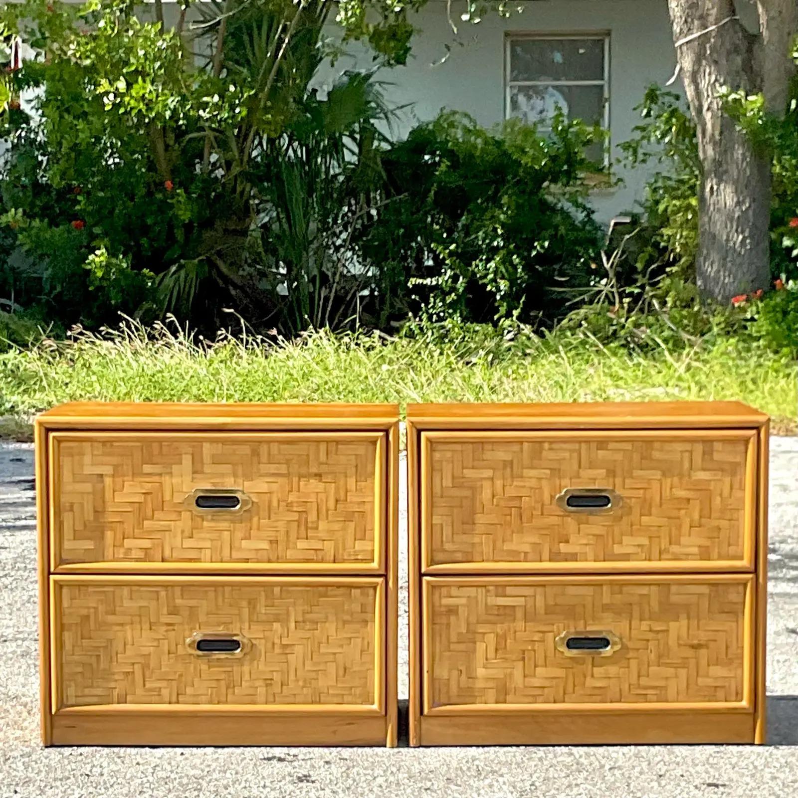 A fabulous pair of vintage Coastal nightstands. Made by the iconic Dixie group. Beautiful parquet rattan with a chic rattan trim. Acquired from a Palm Beach estate.