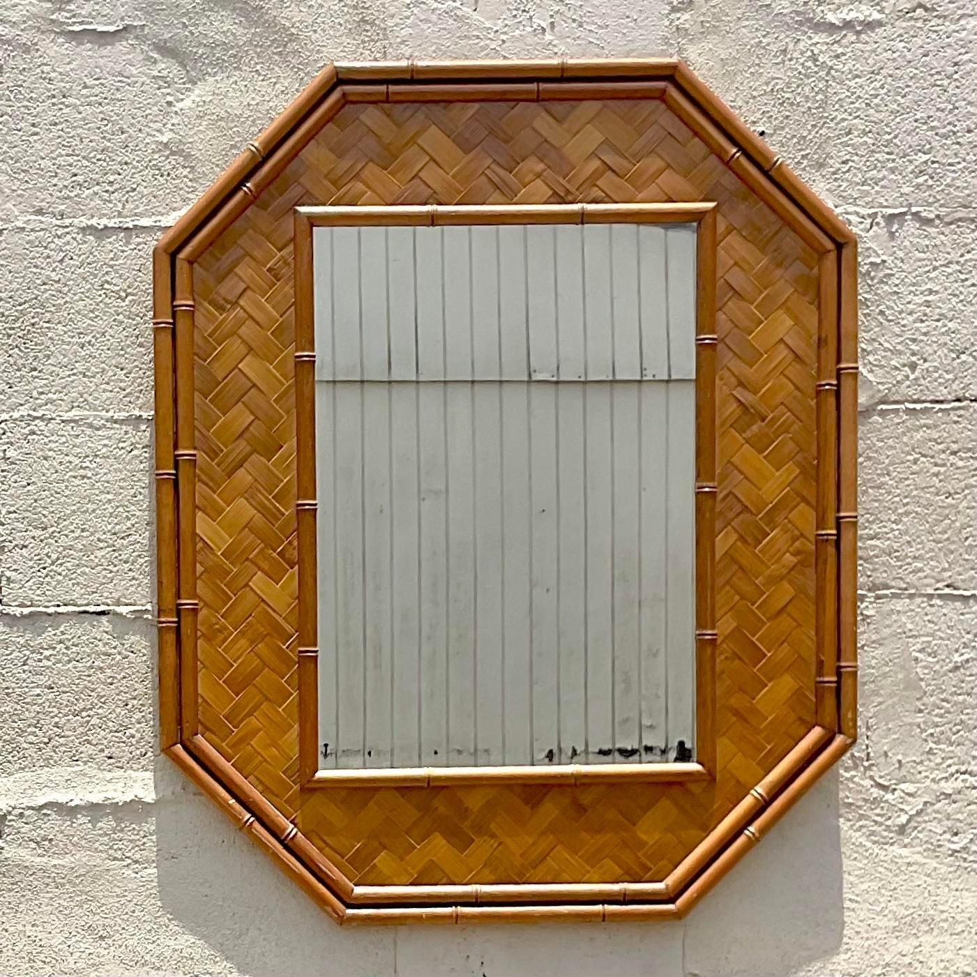 Vintage Coastal Octagon wall mirror. A chic parquet rattan with a solid rattan trim. Acquired from a Palm Beach estate.