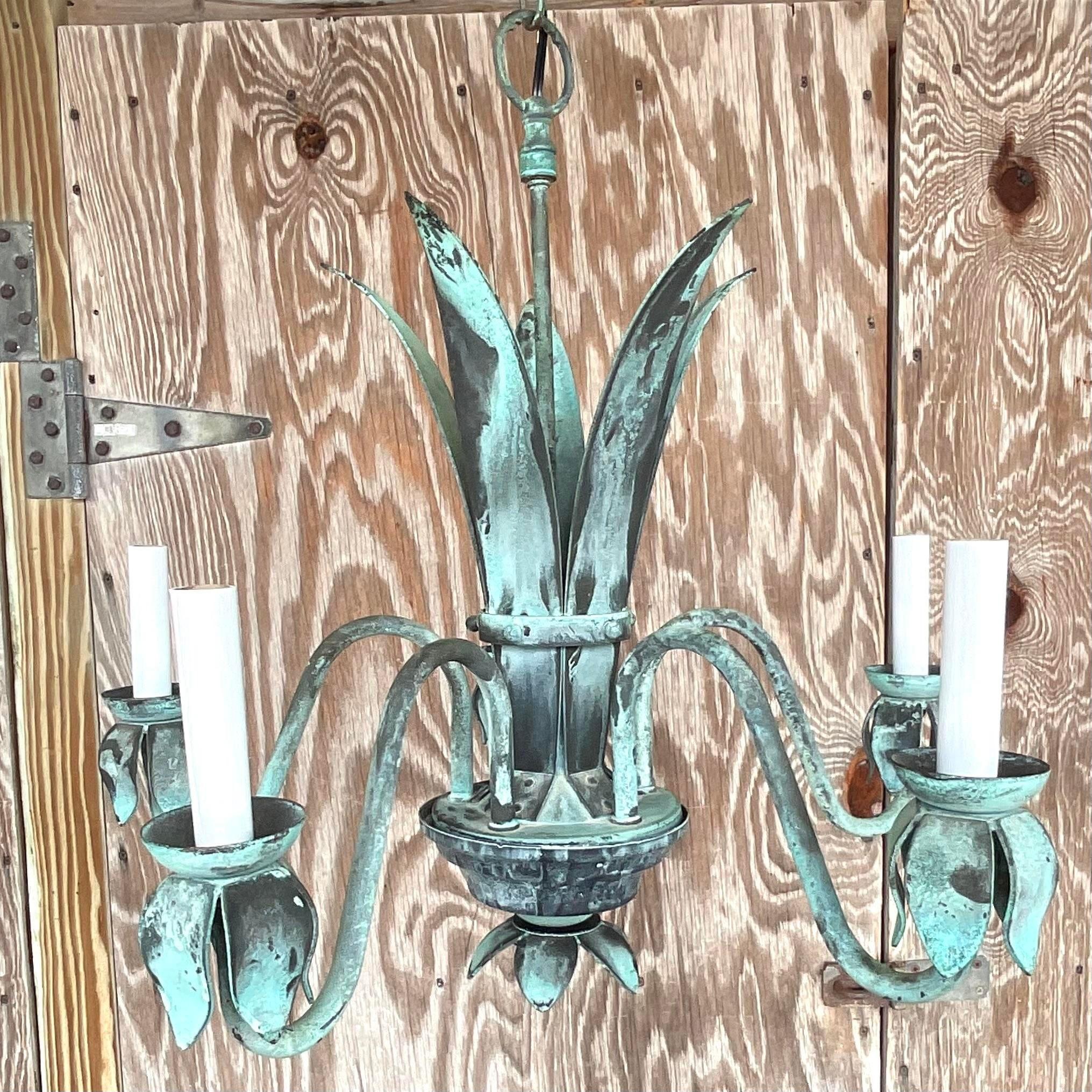 A gorgeous vintage bronze chandelier. A chic patinated finish on a wide leaf design. Acquired from a Palm Beach estate.