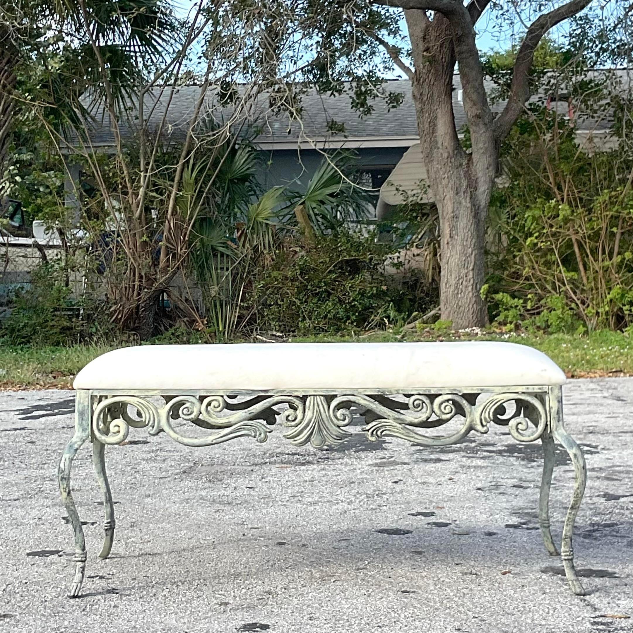 A fantastic vintage Coastal bench. A chic scroll work design on a patinated metal frame. Upholstered seat. Acquired from a Palm Beach estate. 