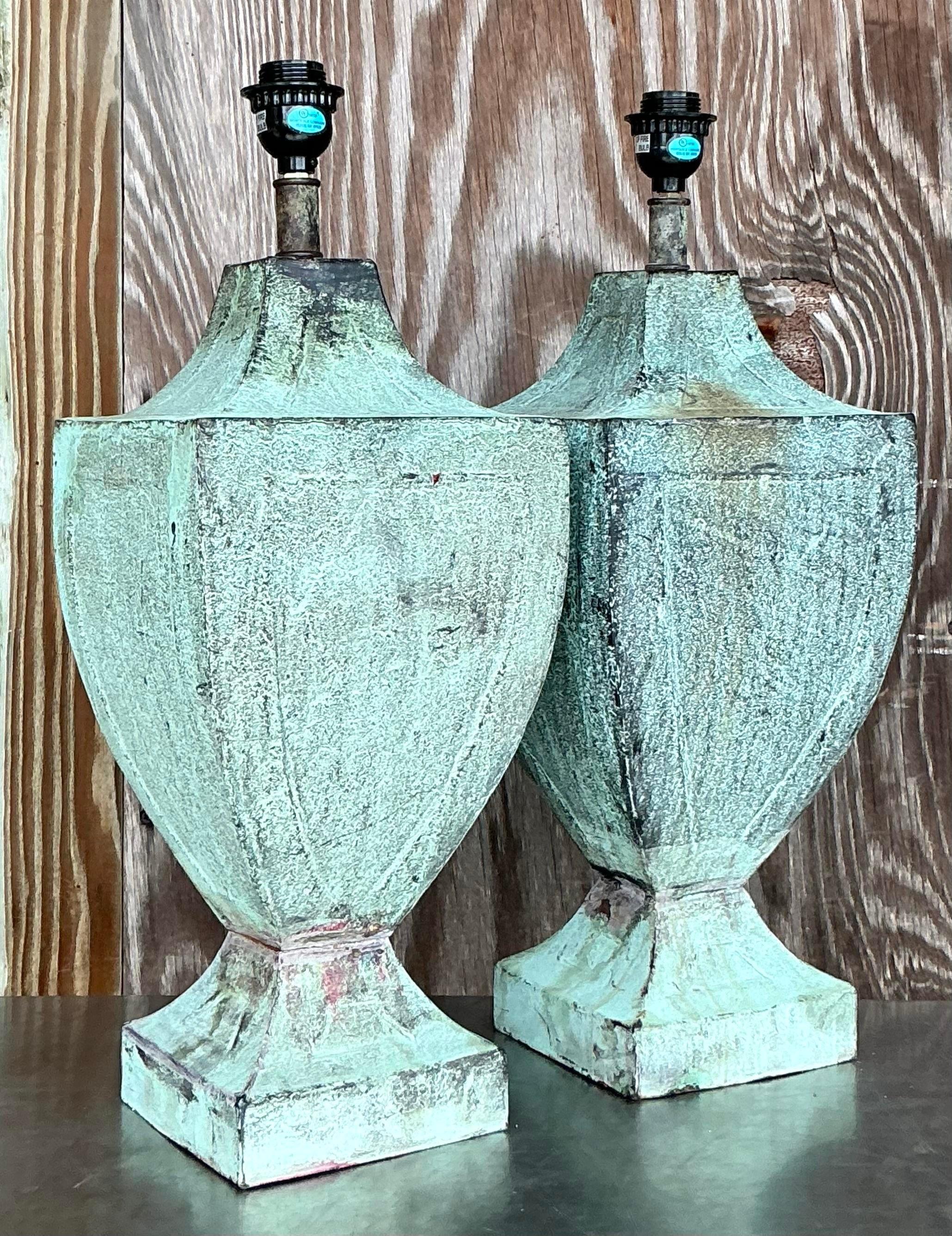 Add a touch of seaside charm to your space with this pair of vintage coastal patinated metal urn lamps. Featuring a beautifully weathered finish, these lamps blend rustic elegance with nautical flair, perfect for any coastal or vintage-inspired