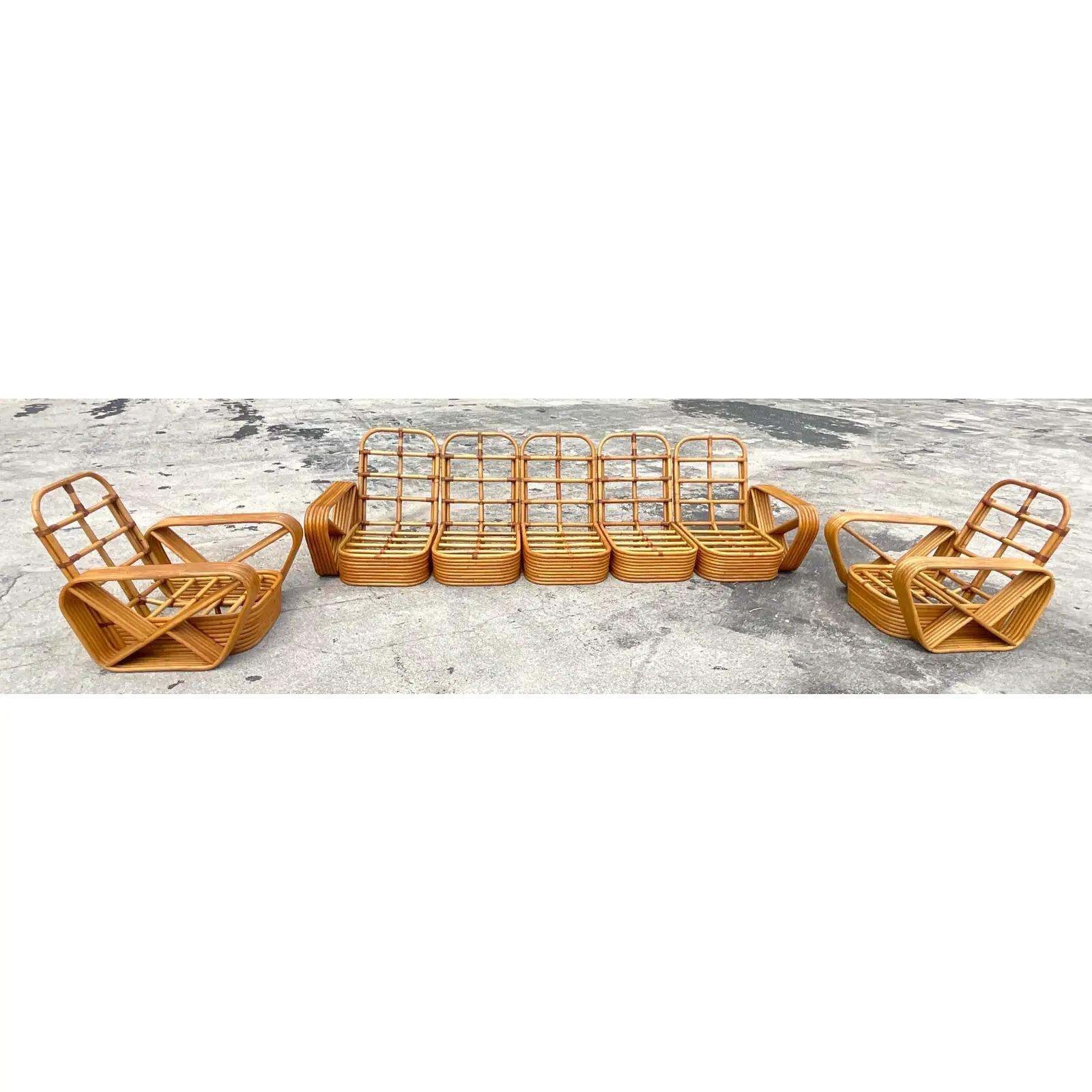 Incredible vintage Coastal rattan sofa. The iconic six strand design made by Paul Frankl. A full set of cushions included with the sofa. Matching pair of lounge chairs also available. Acquired from a NY estate.