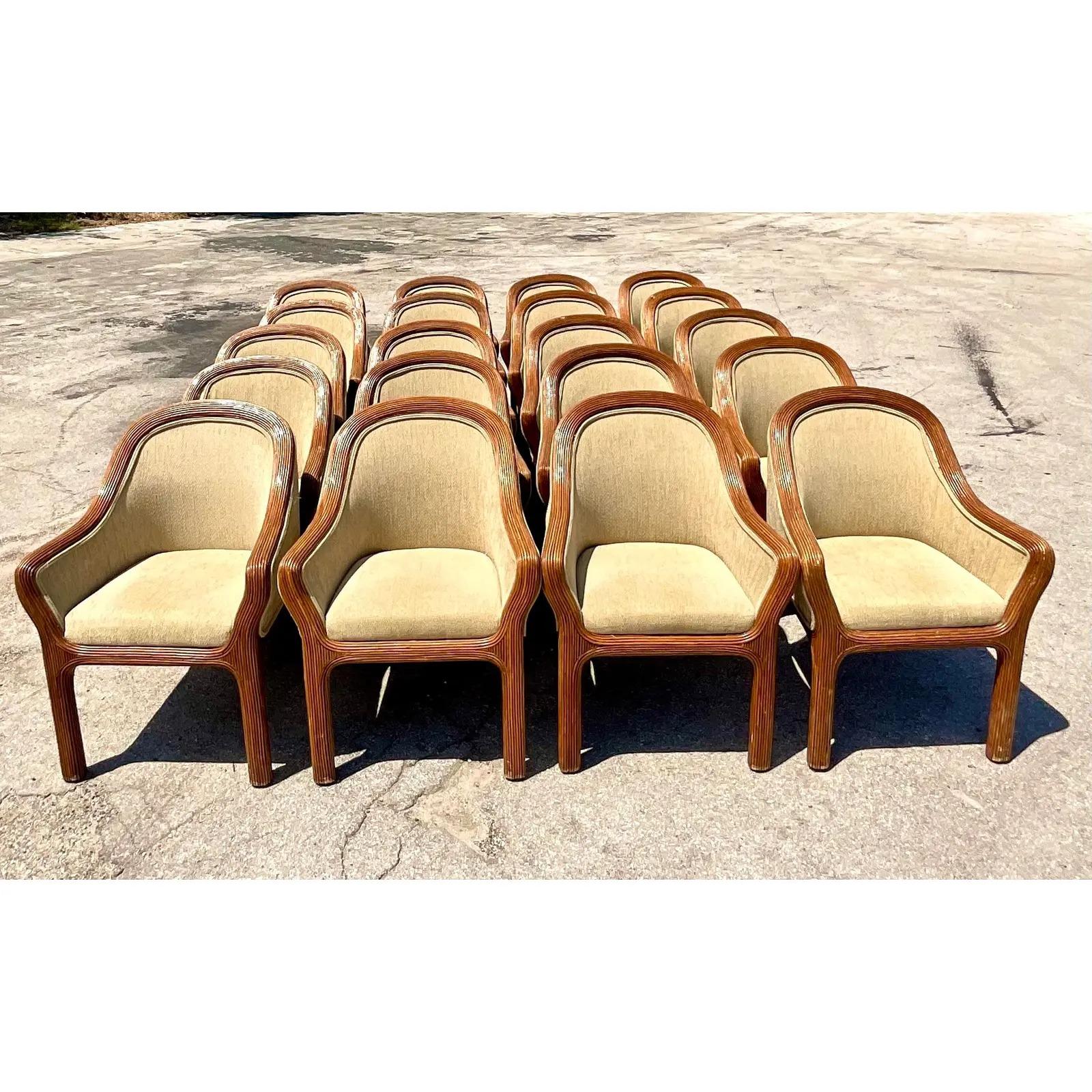 Fantastic set of 20 vintage Coastal dining chairs. Beautiful pencil reed frames with boucle upholstery in a chic neutral. Acquired from a Palm Beach estate.