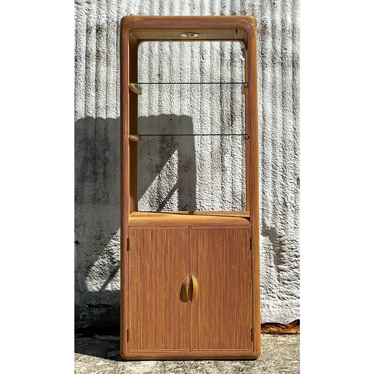 Bring coastal elegance to your space with this Vintage Coastal Pencil Reed Etagere. Featuring a stunning pencil reed design, this etagere blends natural texture with open shelving for a breezy, relaxed vibe. Perfect for displaying your favorite